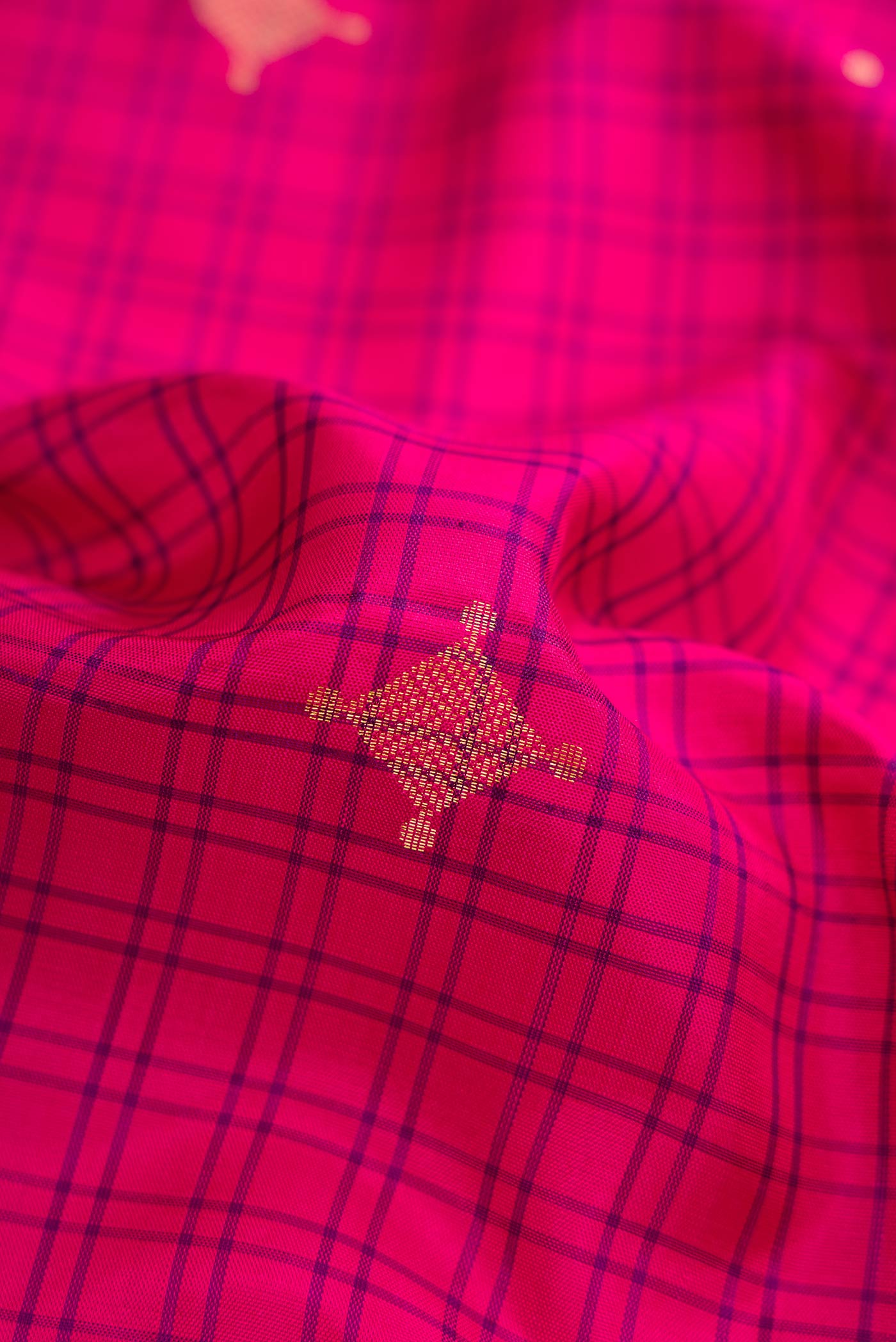 Close up of Pink Dual Tone Soft Silk Saree with Zari Butta on the body and Zari Border.  displaying folds