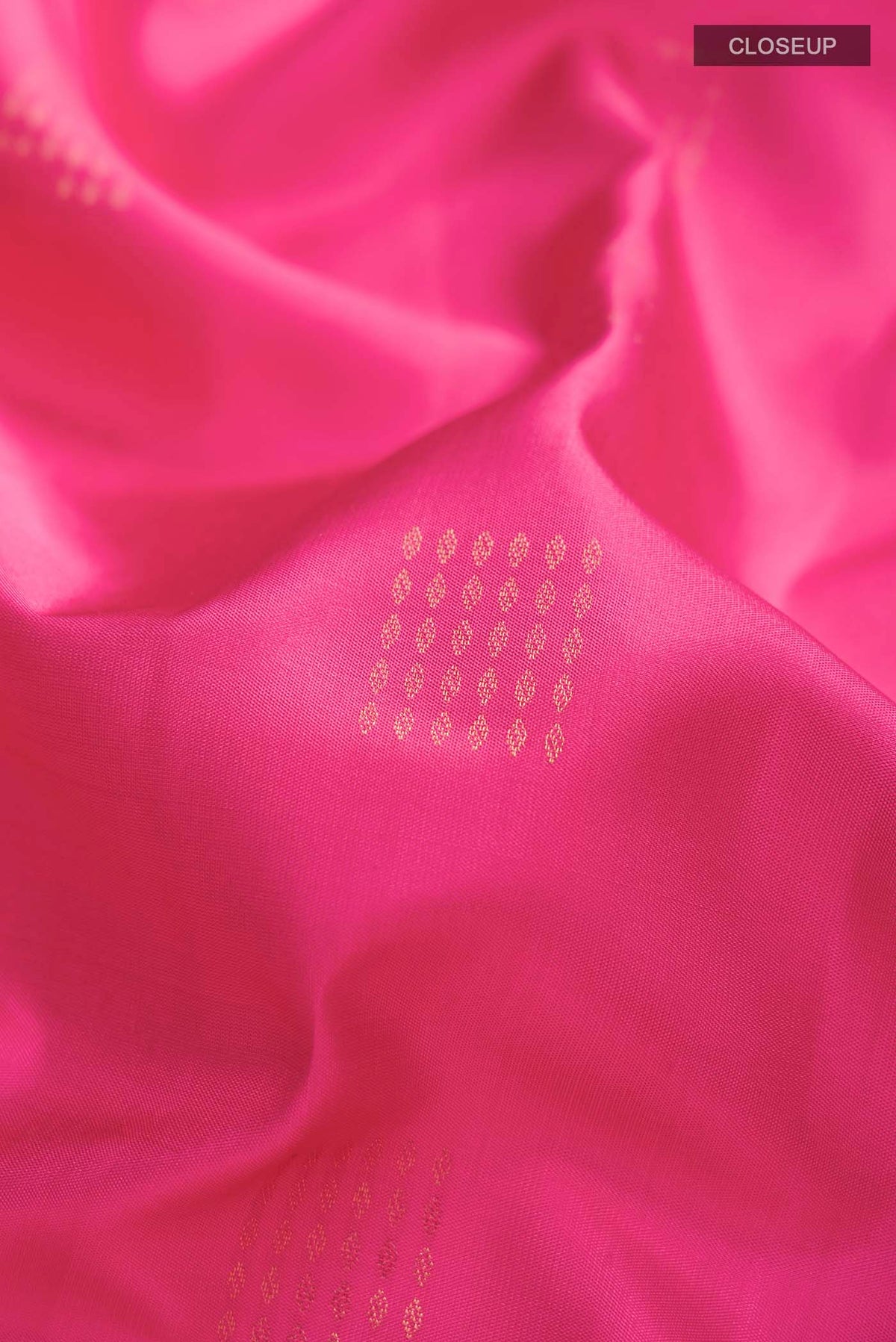 Close up of Pink Soft Silk Saree with Zari Butta on the body and Zari Border displaying folds