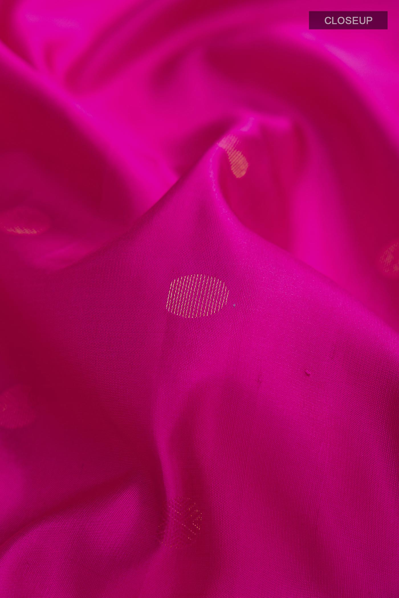 Close up of Pink Soft Silk Saree with Zari Butta on the body and Zari Border displaying folds