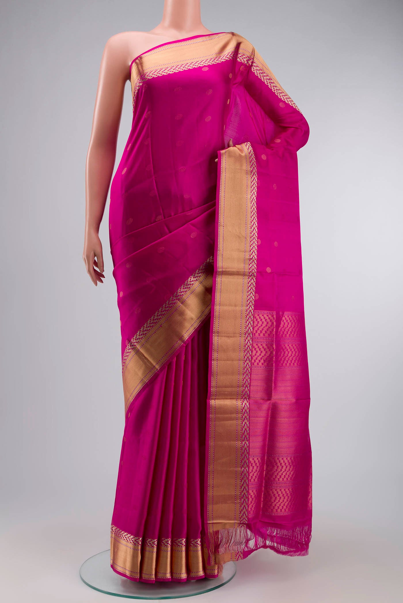 Pink Soft Silk Saree with Zari Butta on the body and Zari Border displayed on a mannequin