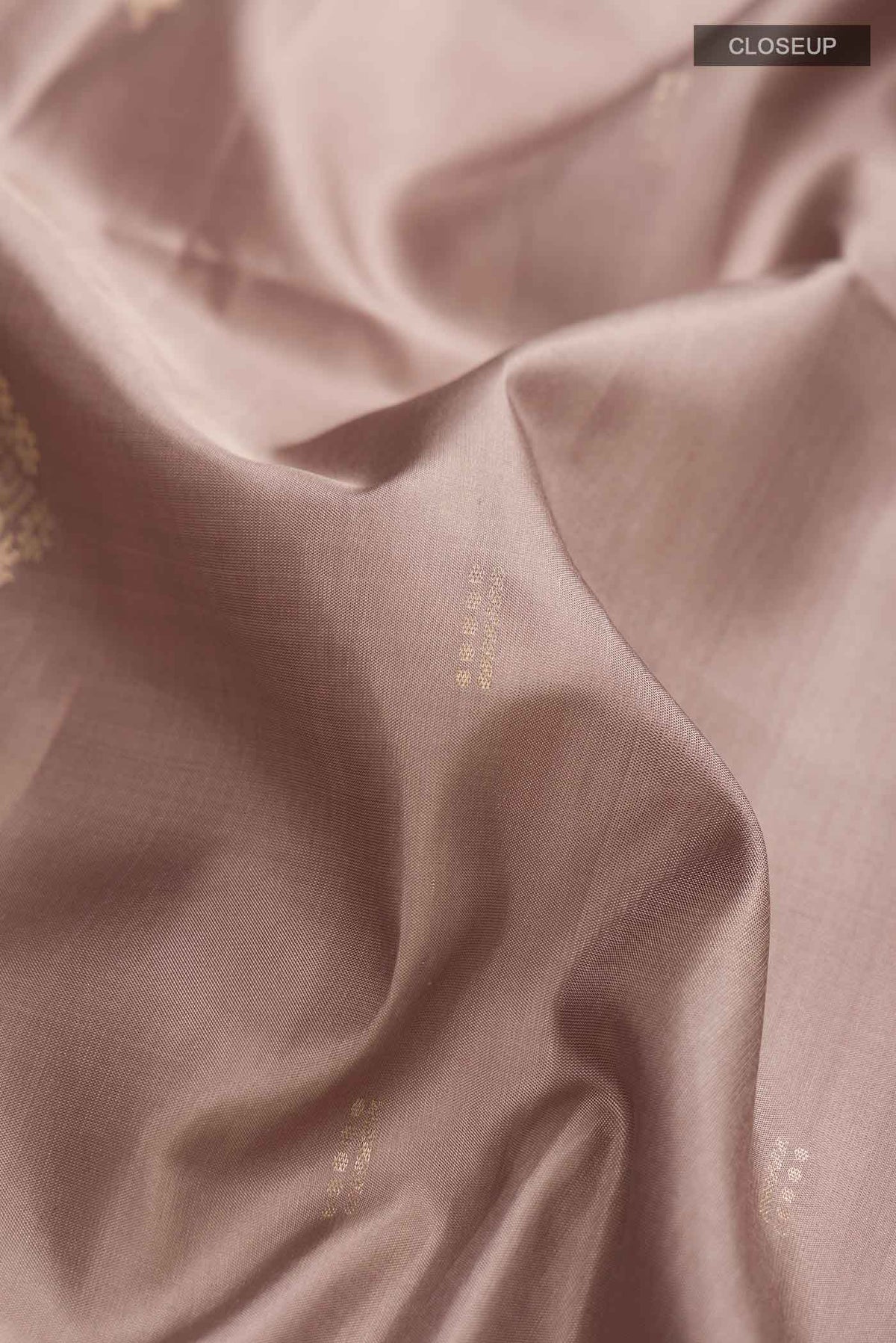 Close up of Grey Soft Silk Saree with Zari Butta on the body and Zari Border displaying folds