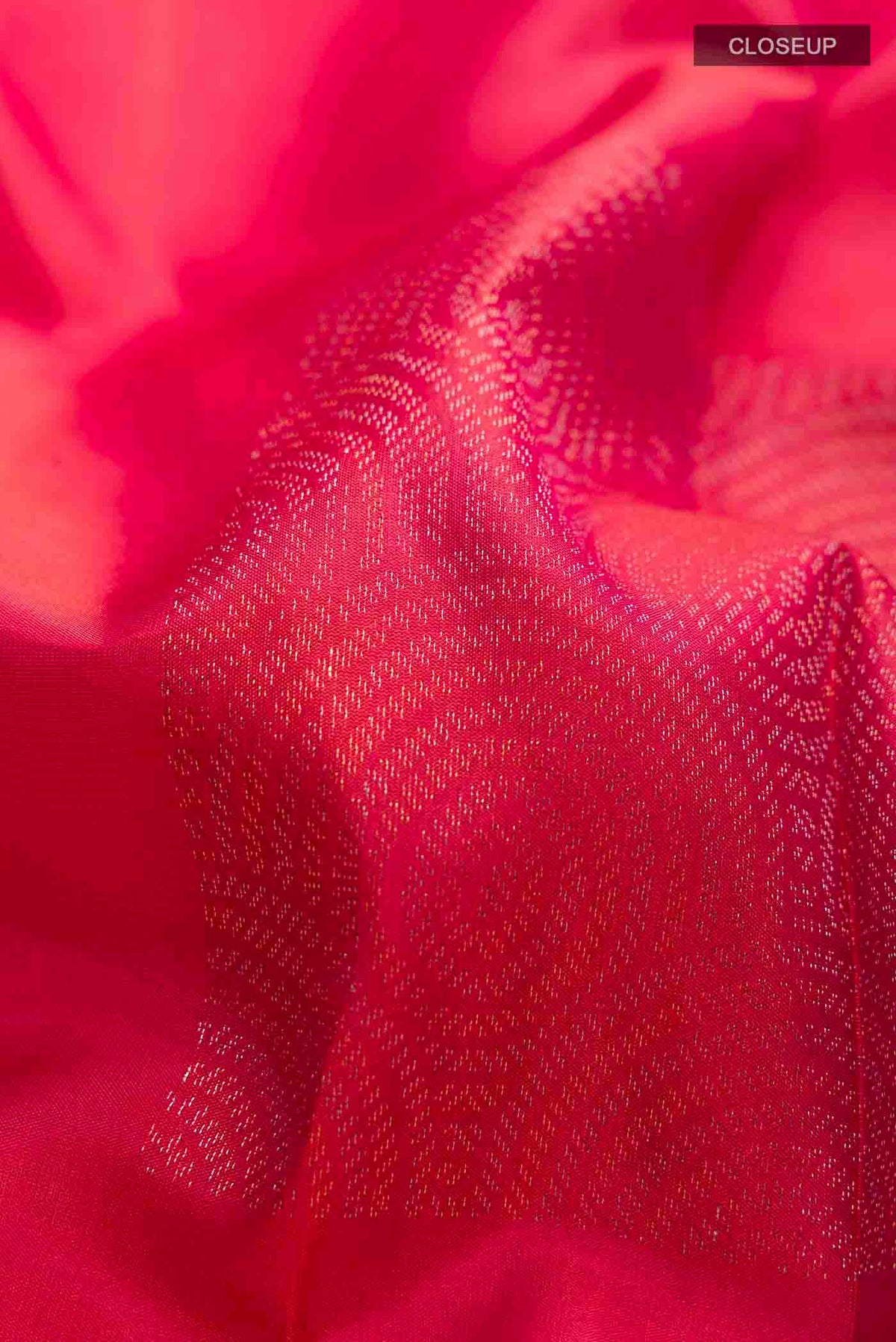 Close up of Pink Soft Silk Saree with Zari Butta on the body and Without Border displaying folds