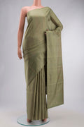 Green Soft Silk Saree with Zari Butta on the body and Zari Border displayed on a mannequin