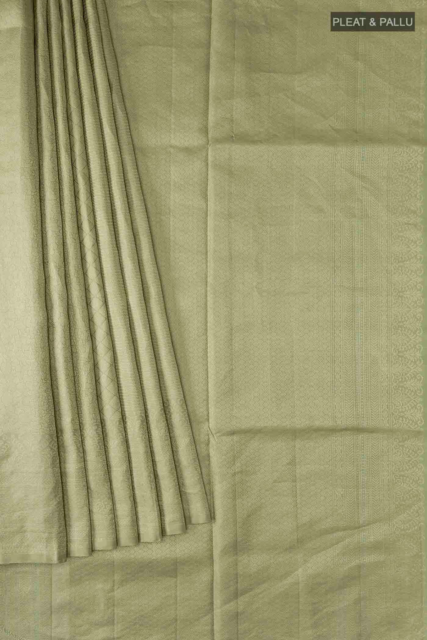 Pleats and pallu of Green Soft Silk Saree with Zari Butta on the body and Zari Border