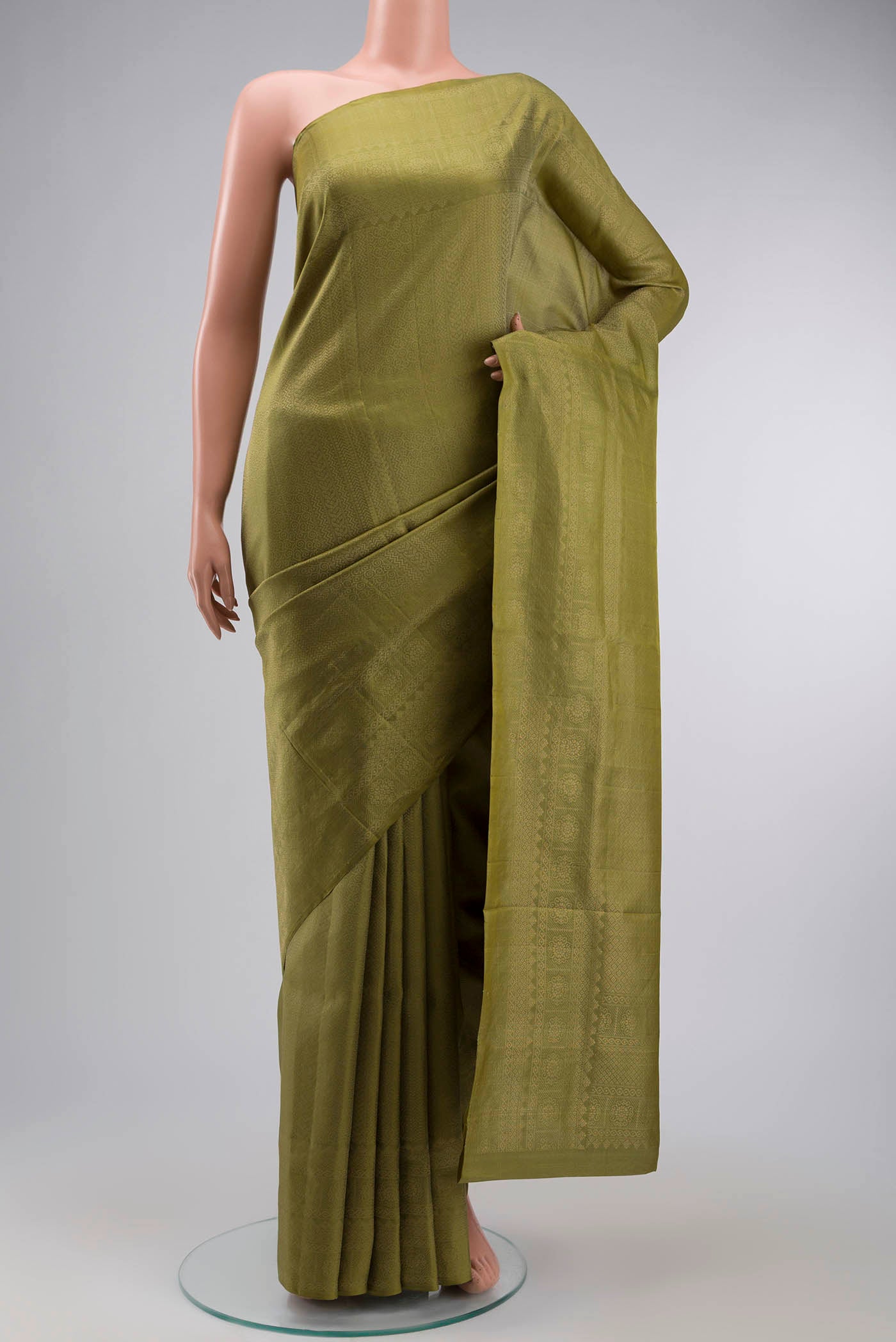 Green Soft Silk Saree with Zari Brocade on the body and Zari Border displayed on a mannequin