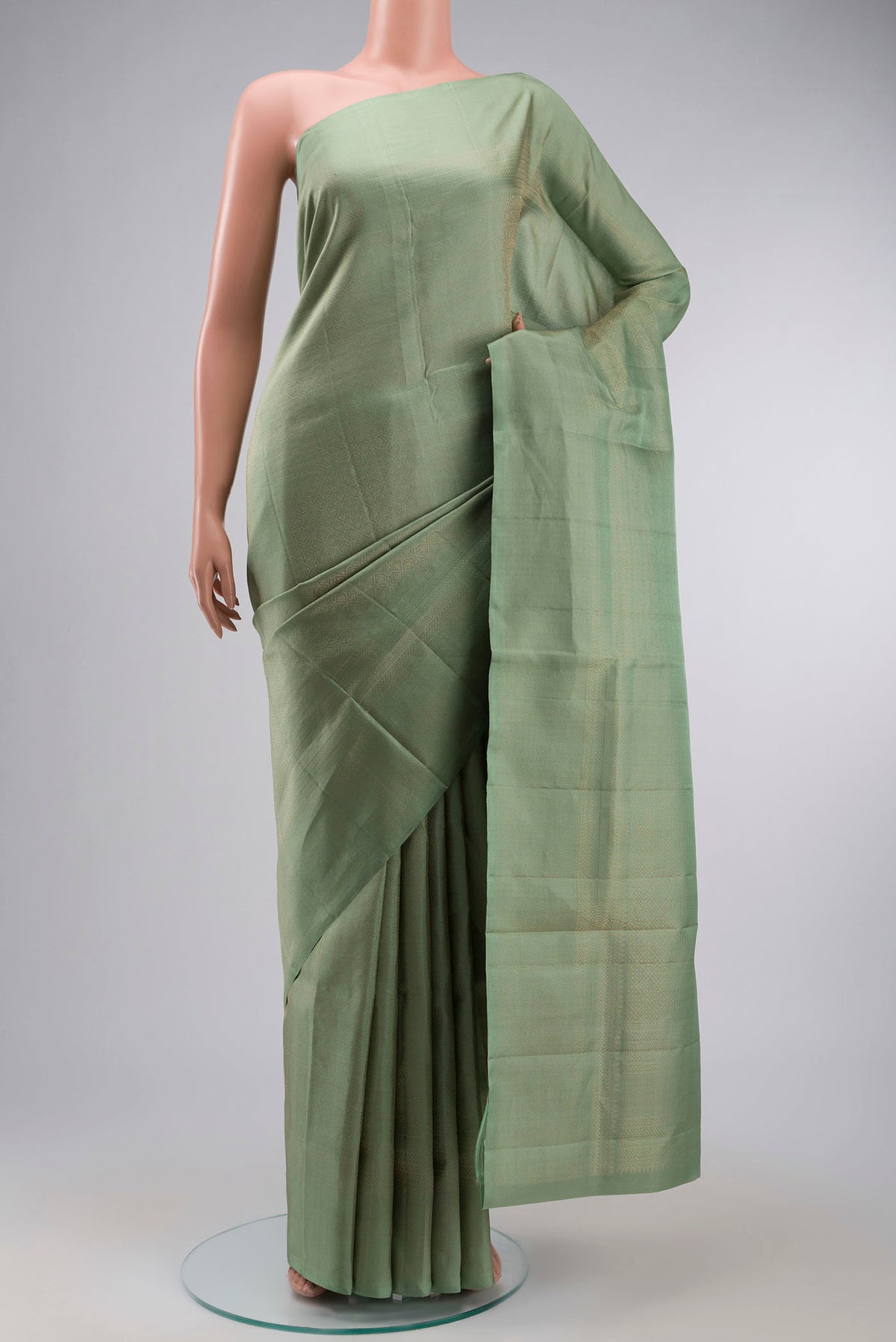 Green Soft Silk Saree with Zari Brocade on the body and Zari Border displayed on a mannequin