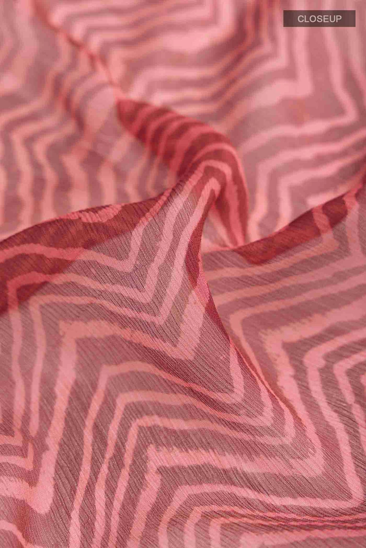 Close up of Bronze Mysore Chiffon Saree with Printed design on the body and Plain Border displaying folds