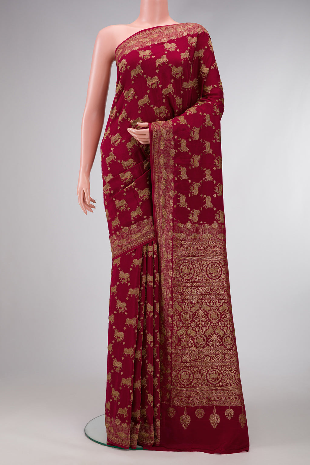 Maroon Dual Tone Banarasi Georgette Saree with Zari Brocade on the body and Fancy Border.  displayed on a mannequin