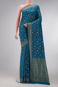 Peacock Blue Dual Tone Banarasi Georgette Saree with Zari Brocade on the body and Zari Border.  displayed on a mannequin