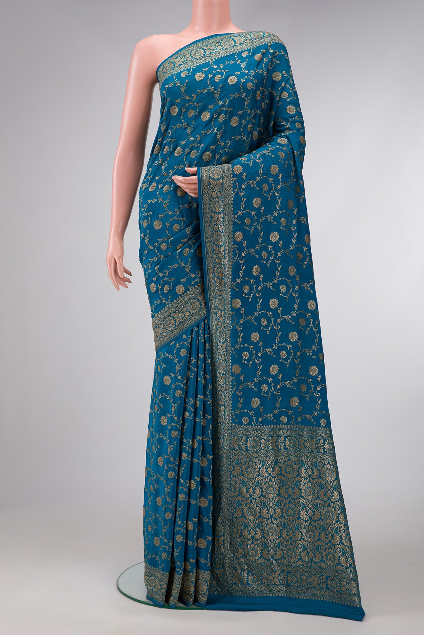 Peacock Blue Dual Tone Banarasi Georgette Saree with Zari Brocade on the body and Zari Border.  displayed on a mannequin