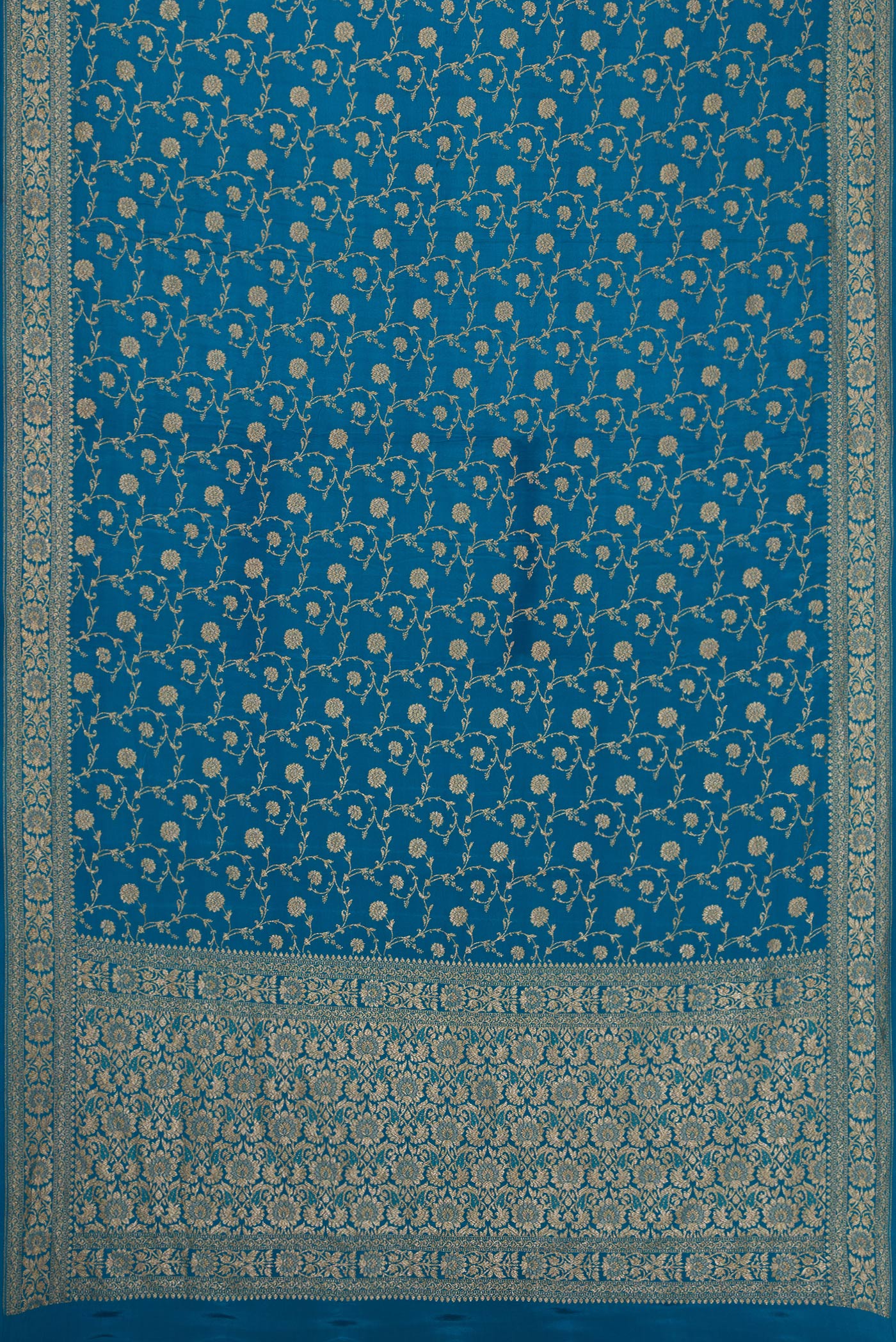 Flat view of Peacock Blue Dual Tone Banarasi Georgette Saree with Zari Brocade on the body and Zari Border. 
