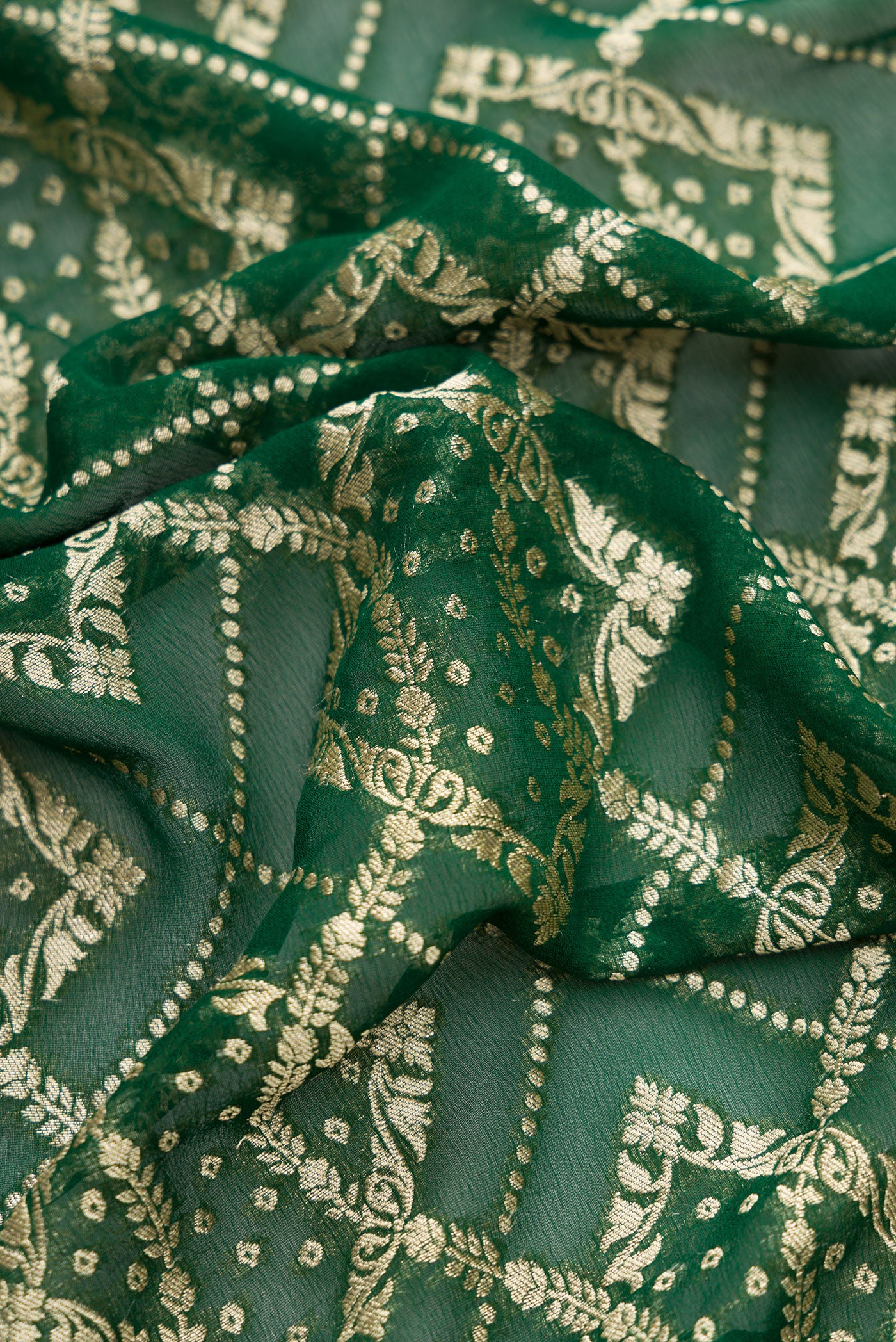 Close up of Bottle Green Dual Tone Banarasi Georgette Saree with Zari Brocade on the body and Zari Border.  displaying folds