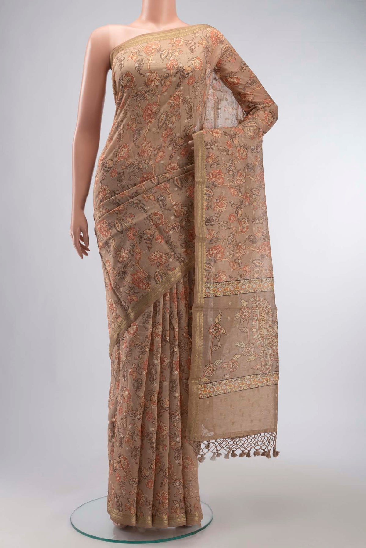 Brown Silk Cotton Saree with Printed design on the body and Zari Border displayed on a mannequin