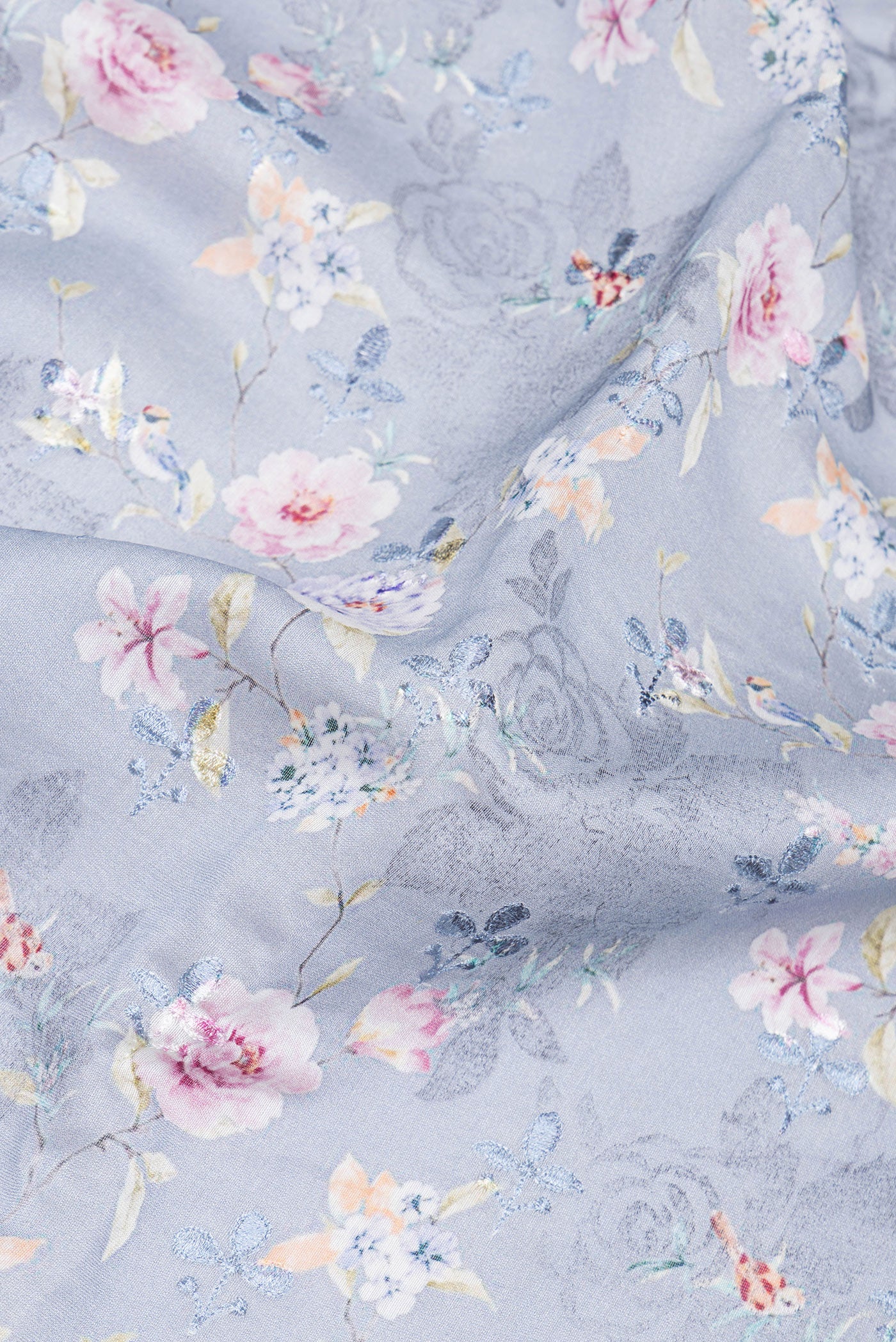 Close up of Grey Chanderi Silk Cotton Saree with Printed design on the body and Zari And Thread Border.  displaying folds