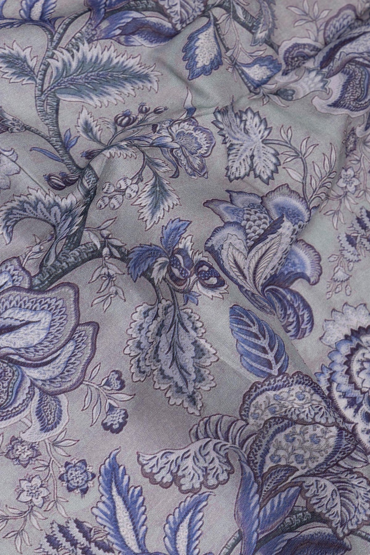 Close up of Pure Silk Grey Dual Tone Chanderi Saree with Printed design on the body and Zari Border.  displaying folds