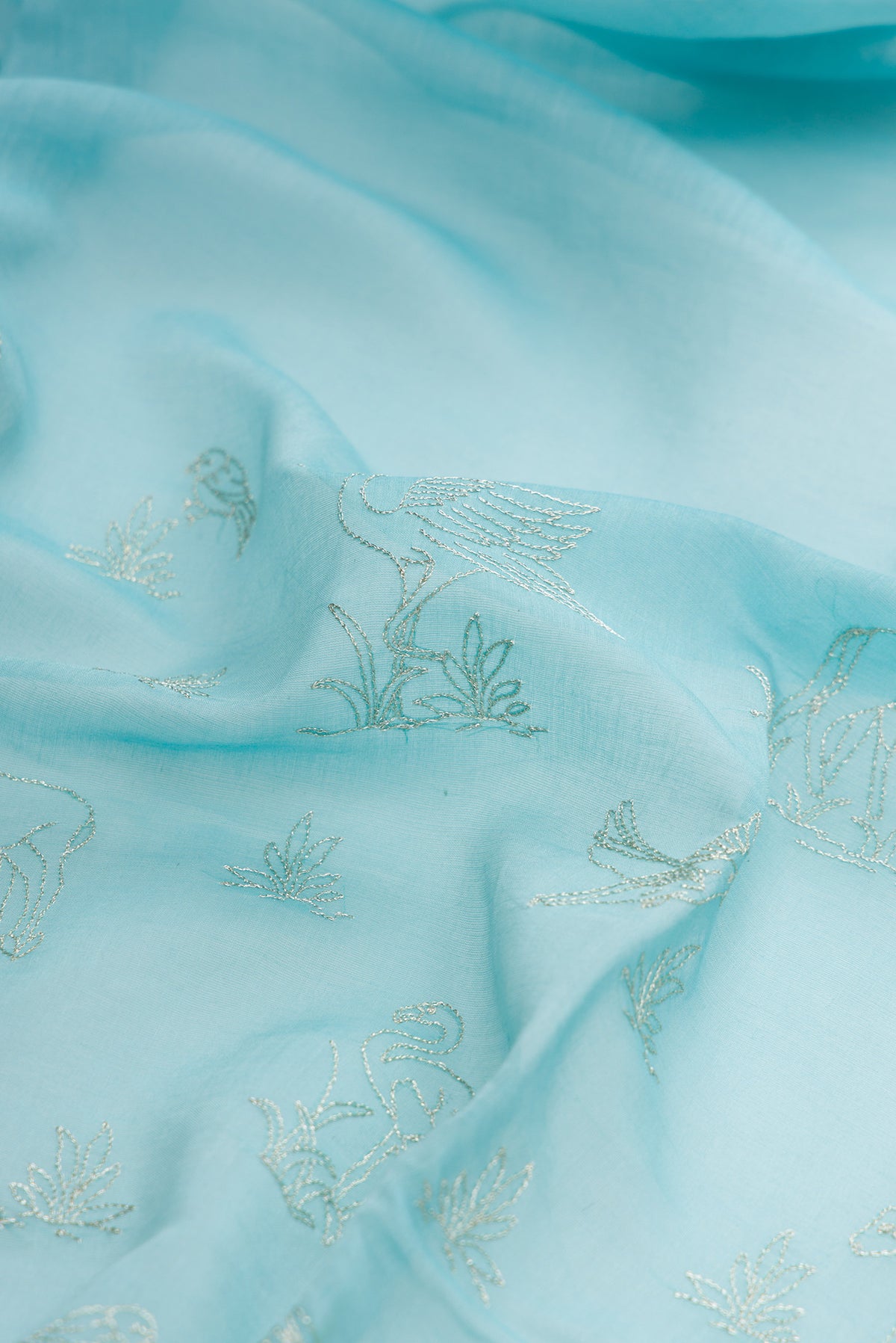 Close up of Sky Blue Dual Tone Chanderi Silk Saree with Zari Butta on the body and Zari Border.  displaying folds