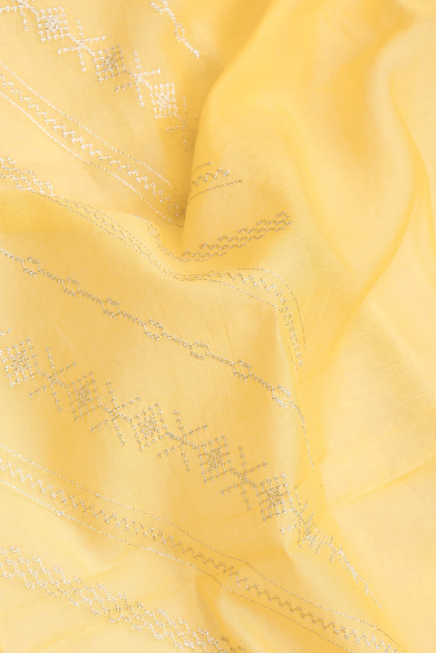Close up of Yellow Dual Tone Chanderi Silk Saree with Embroidery on the body and Embroidery Border.  displaying folds