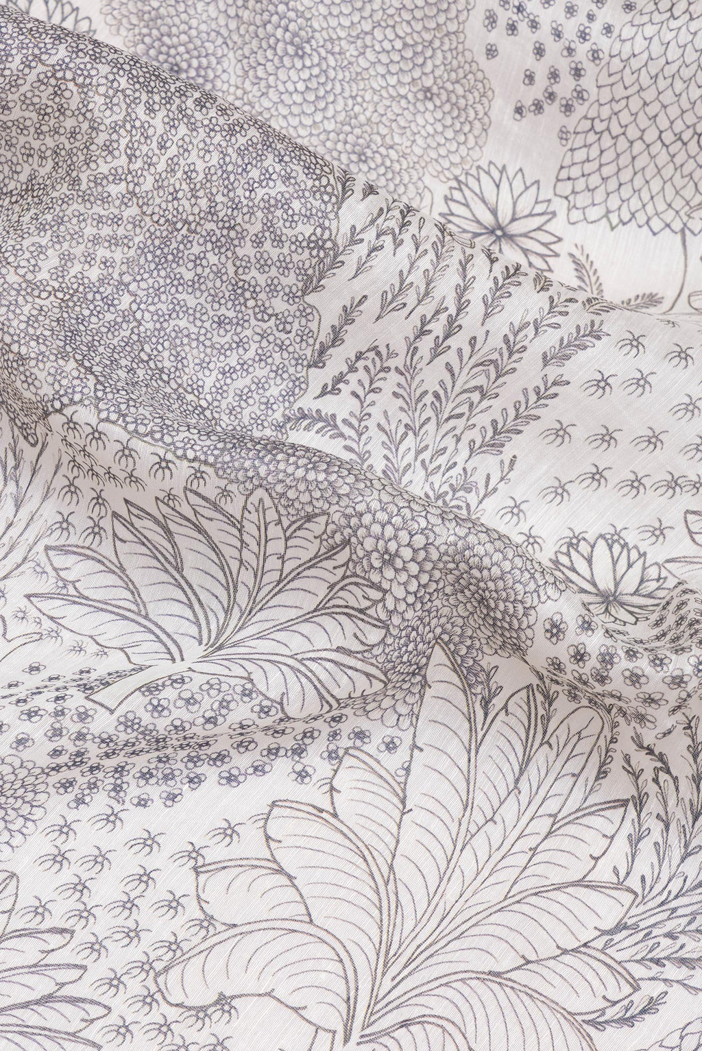 Close up of Off White Linen Saree with Printed design on the body and Embroidery Border.  displaying folds
