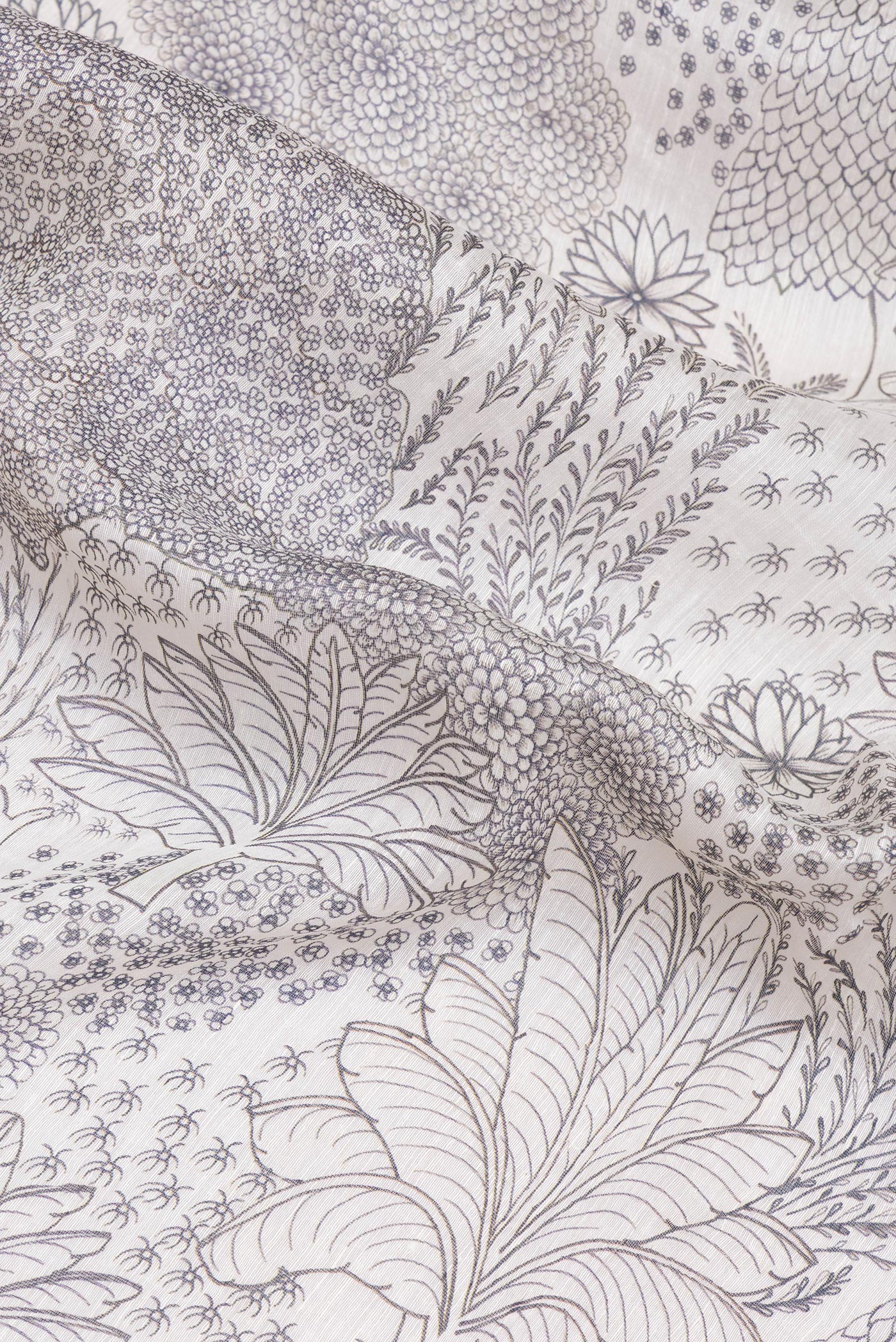 Close up of Off White Linen Saree with Printed design on the body and Embroidery Border.  displaying folds