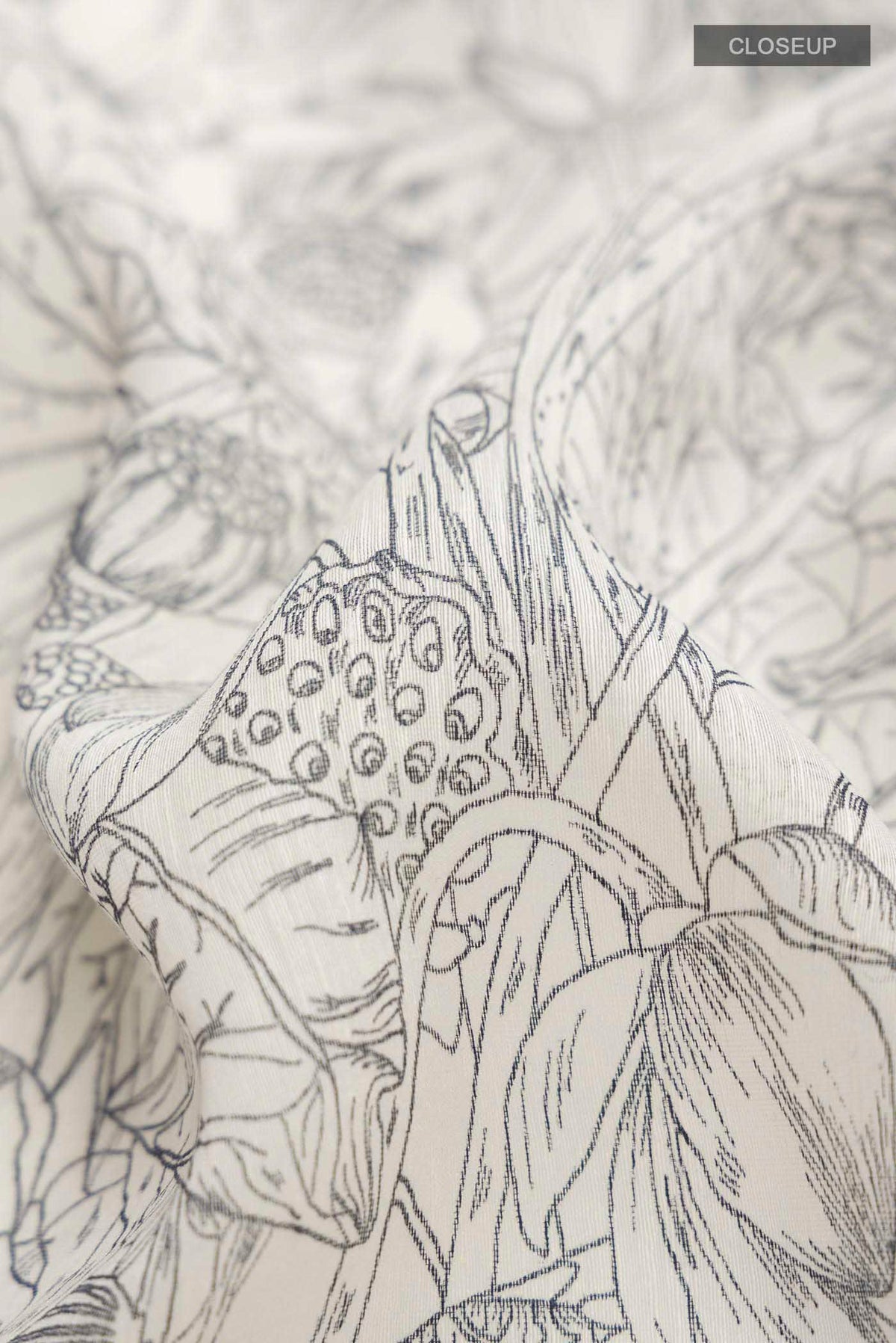 Close up of White Bhagalpuri Tussar Silk Saree with Printed design on the body and Zari Border displaying folds