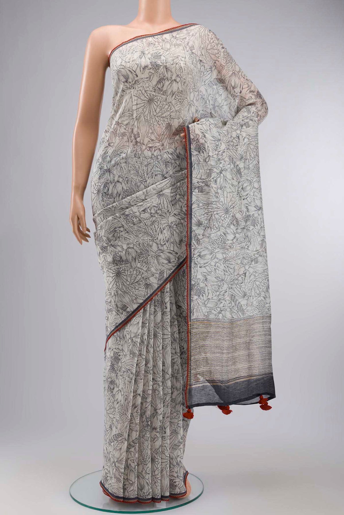 White Bhagalpuri Tussar Silk Saree with Printed design on the body and Zari Border displayed on a mannequin