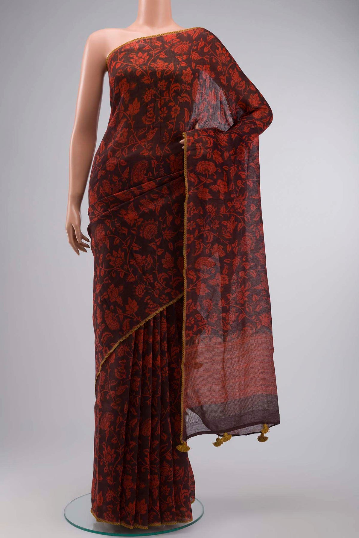 Red Linen Cotton Saree with Printed design on the body and Zari Border displayed on a mannequin