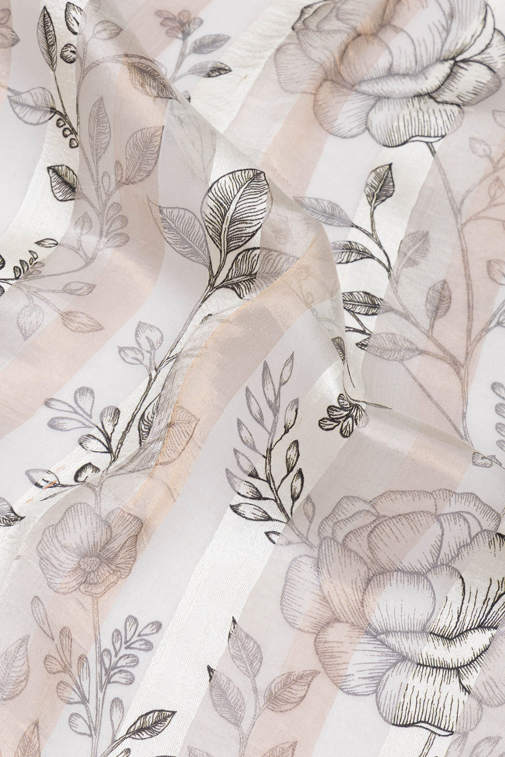 Close up of Off White Tussar Silk Saree with Floral Print on the body and Zari Border.  displaying folds