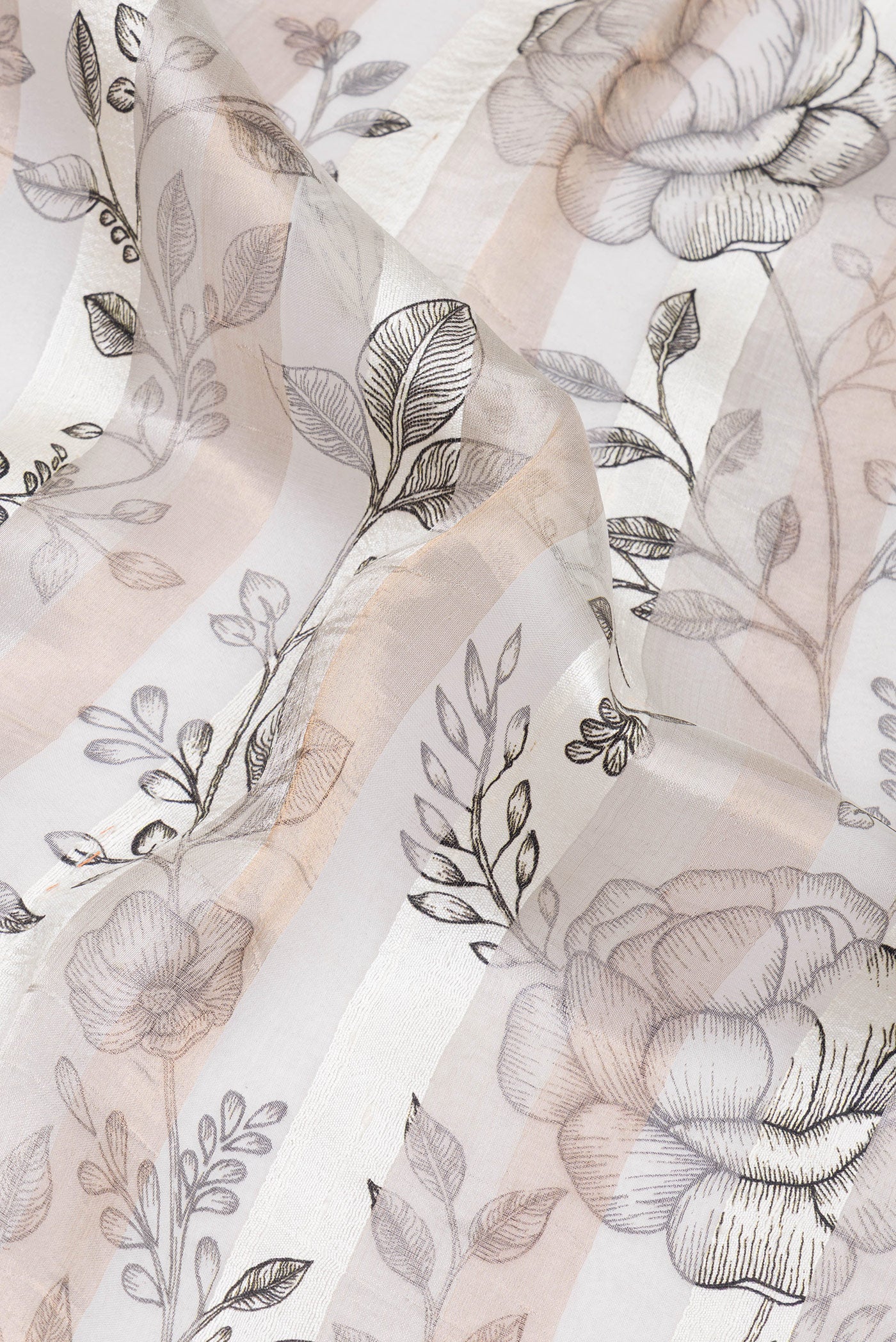 Close up of Off White Tussar Silk Saree with Floral Print on the body and Zari Border.  displaying folds