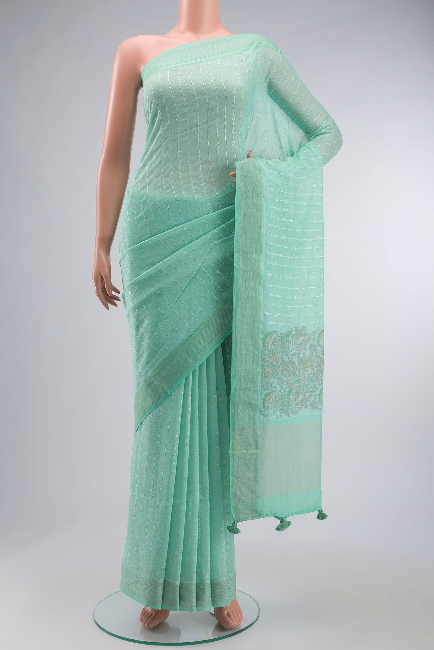 Green Silk Cotton Saree with Printed design on the body and Zari Border displayed on a mannequin
