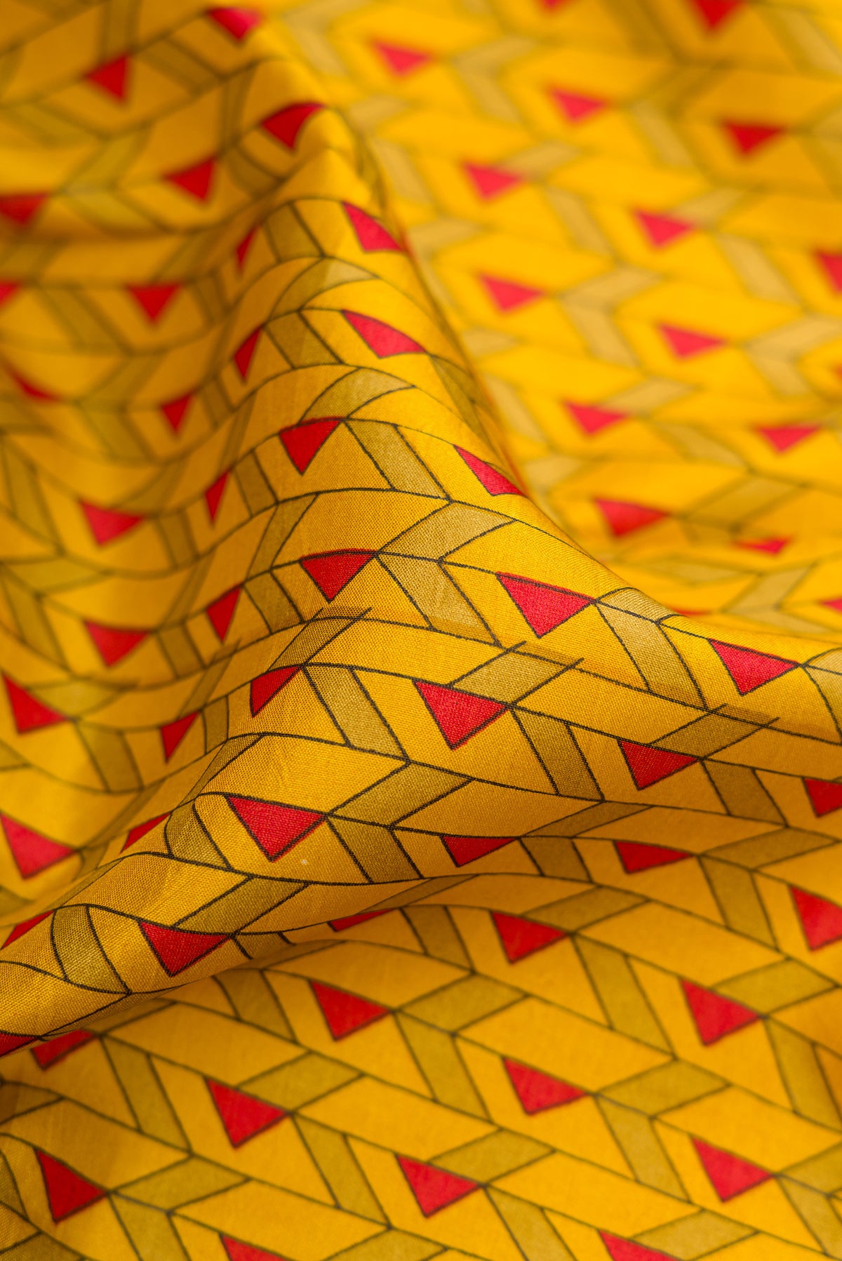 Close up of Mustard Printed Silk Saree with Printed design on the body and Printed Border.  displaying folds