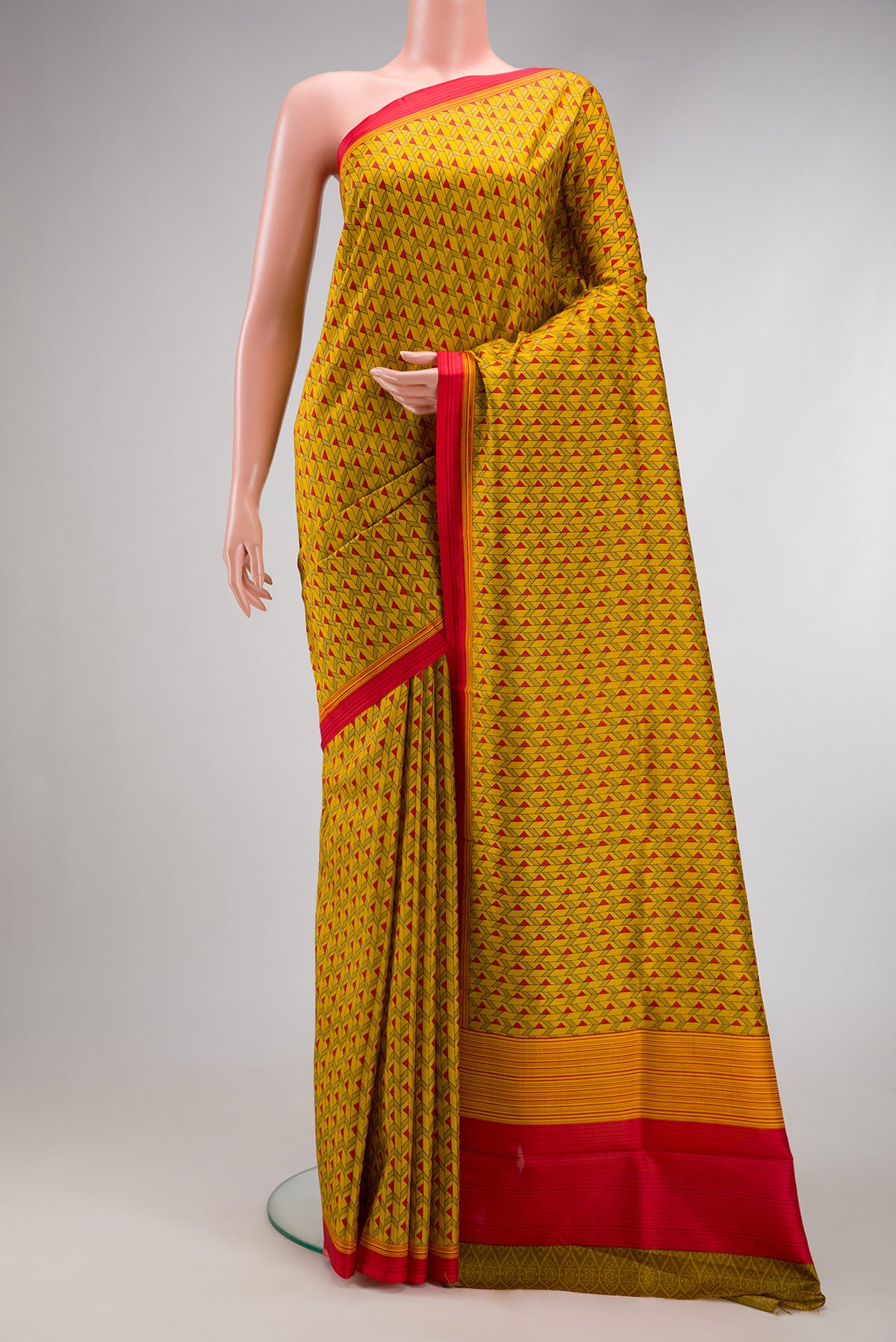Mustard Printed Silk Saree with Printed design on the body and Printed Border.  displayed on a mannequin