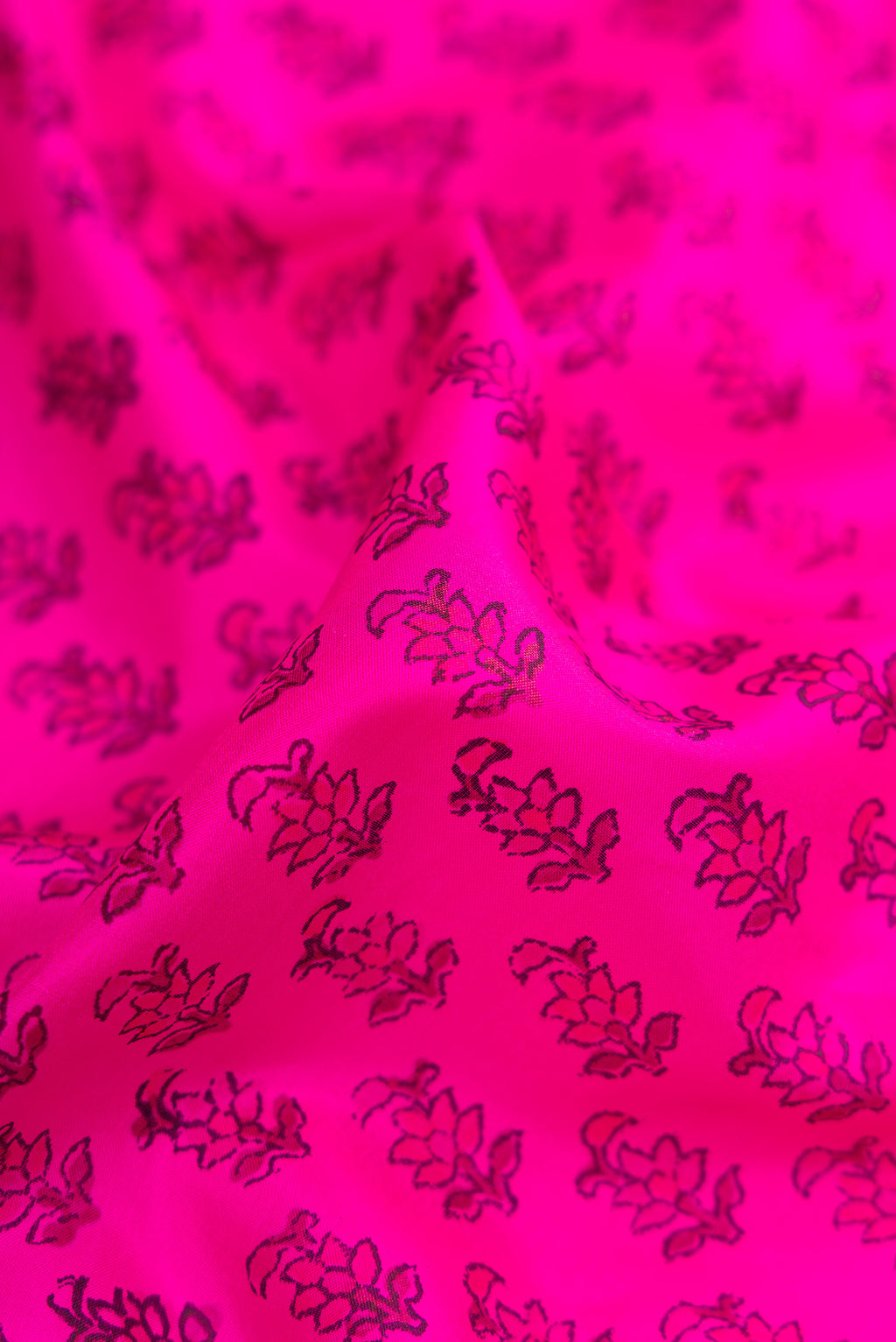 Close up of Dark Pink Dual Tone Printed Silk Saree with Printed design on the body and Printed Border.  displaying folds