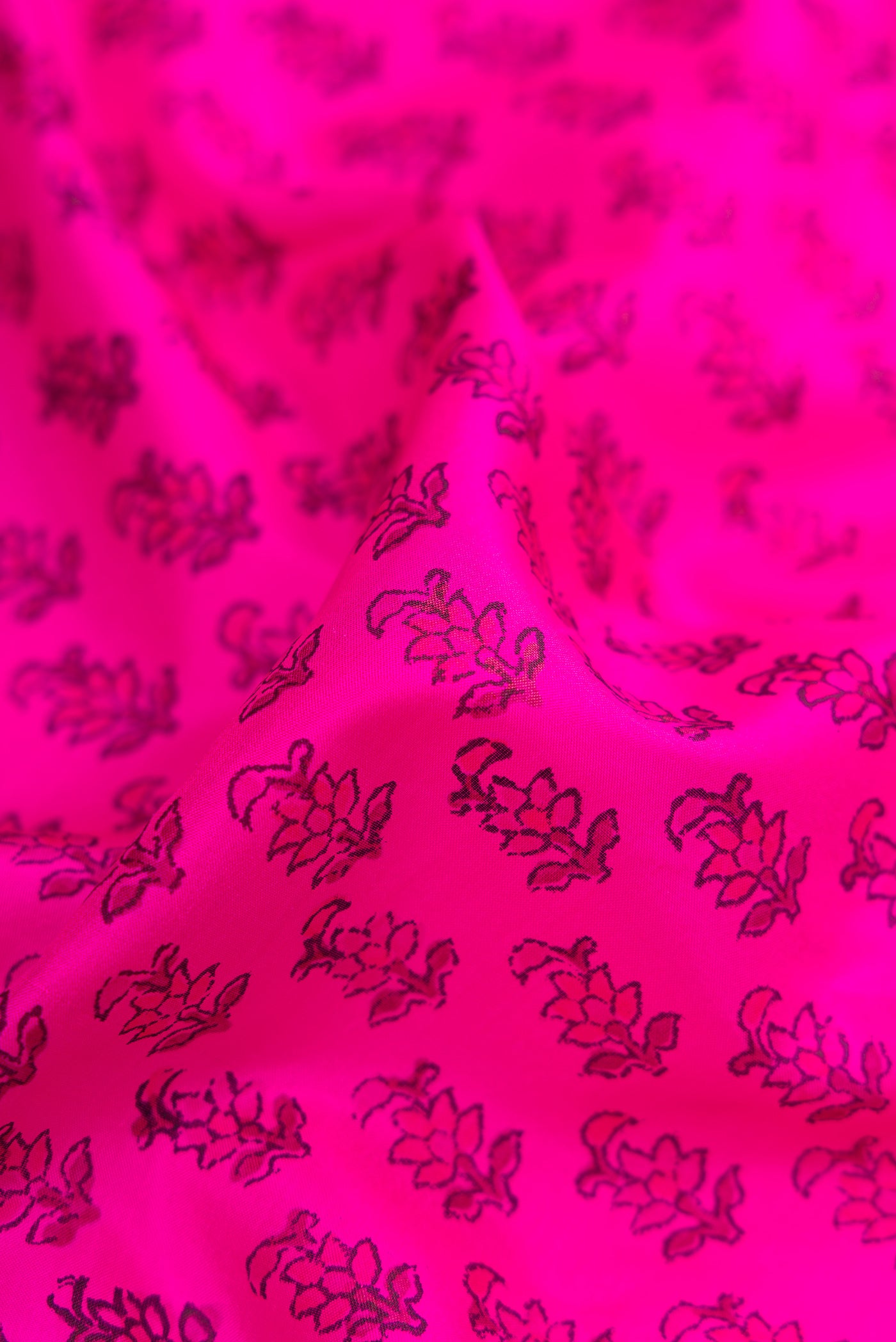 Close up of Dark Pink Dual Tone Printed Silk Saree with Printed design on the body and Printed Border.  displaying folds