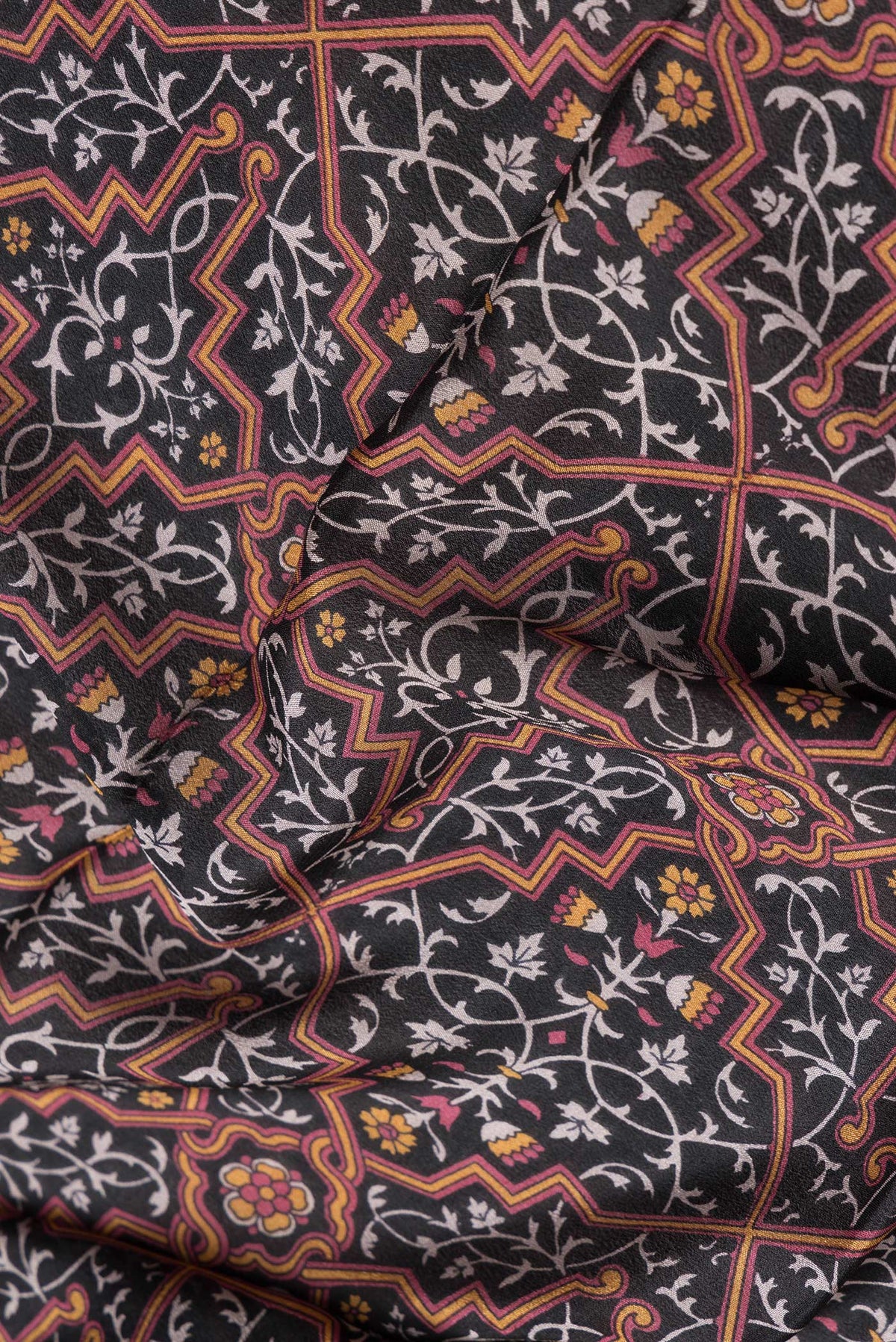 Close up of Black Dual Tone Crepe Saree with Printed design on the body and Thread Border.  displaying folds