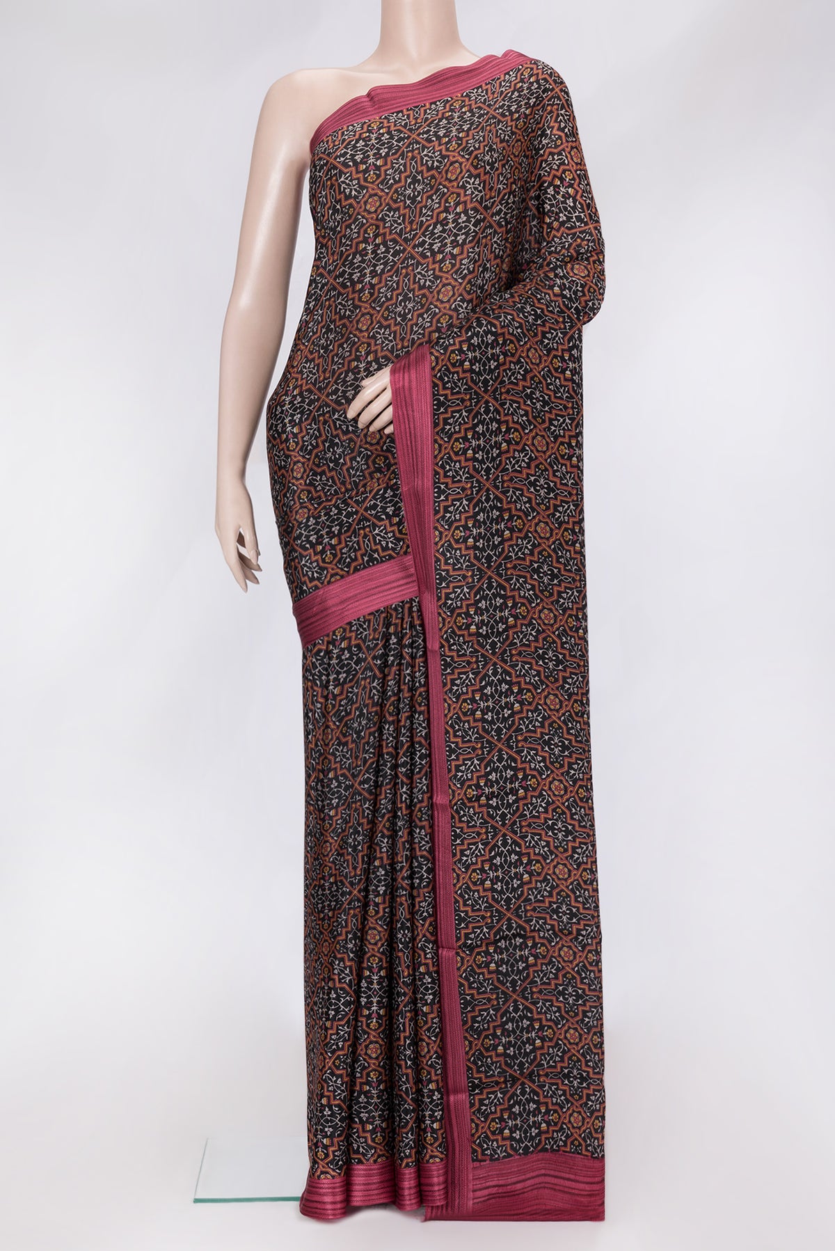 Black Dual Tone Crepe Saree with Printed design on the body and Thread Border.  displayed on a mannequin