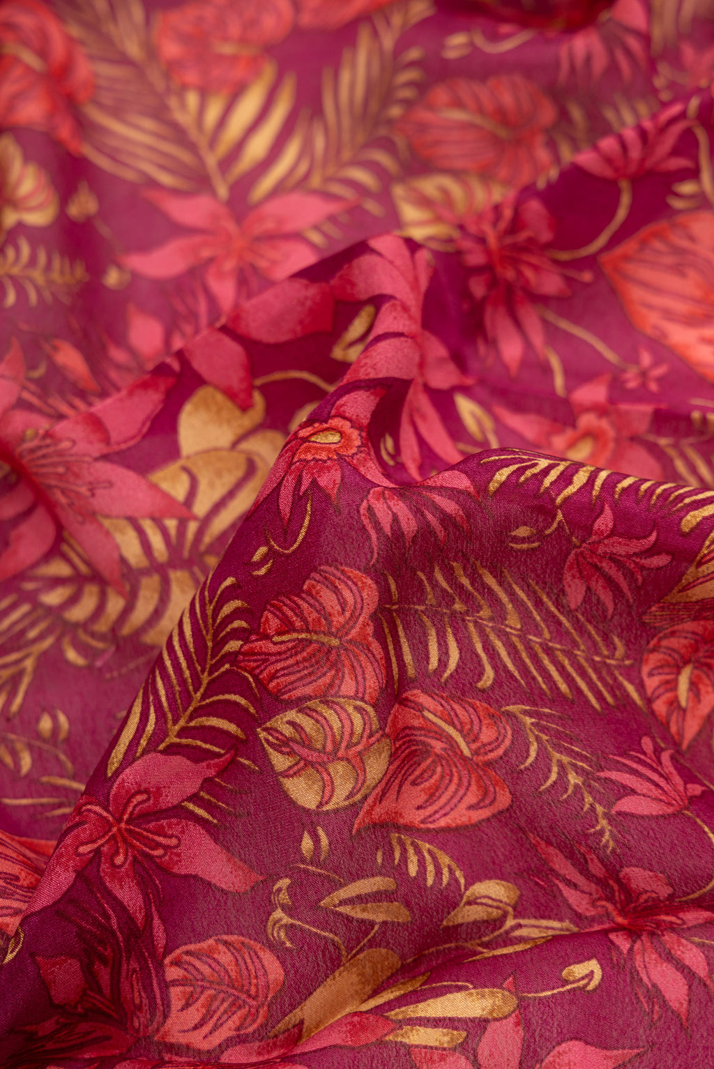 Close up of Magenta Dual Tone Mysore Crepe Saree with Printed design on the body and Thread Border.  displaying folds