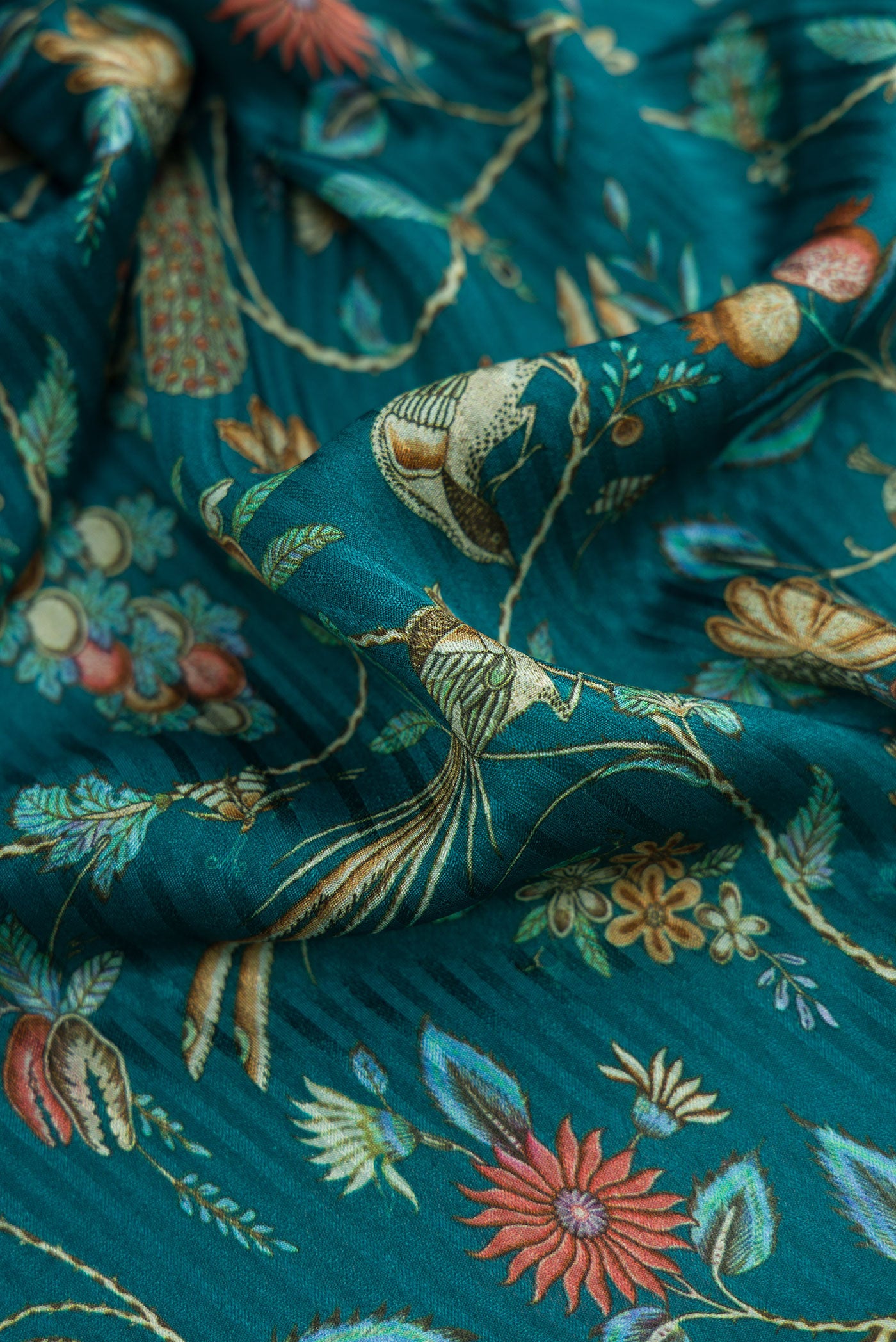 Close up of Peacock Blue Dual Tone Mysore Crepe Saree with Printed design on the body and Zari Border.  displaying folds