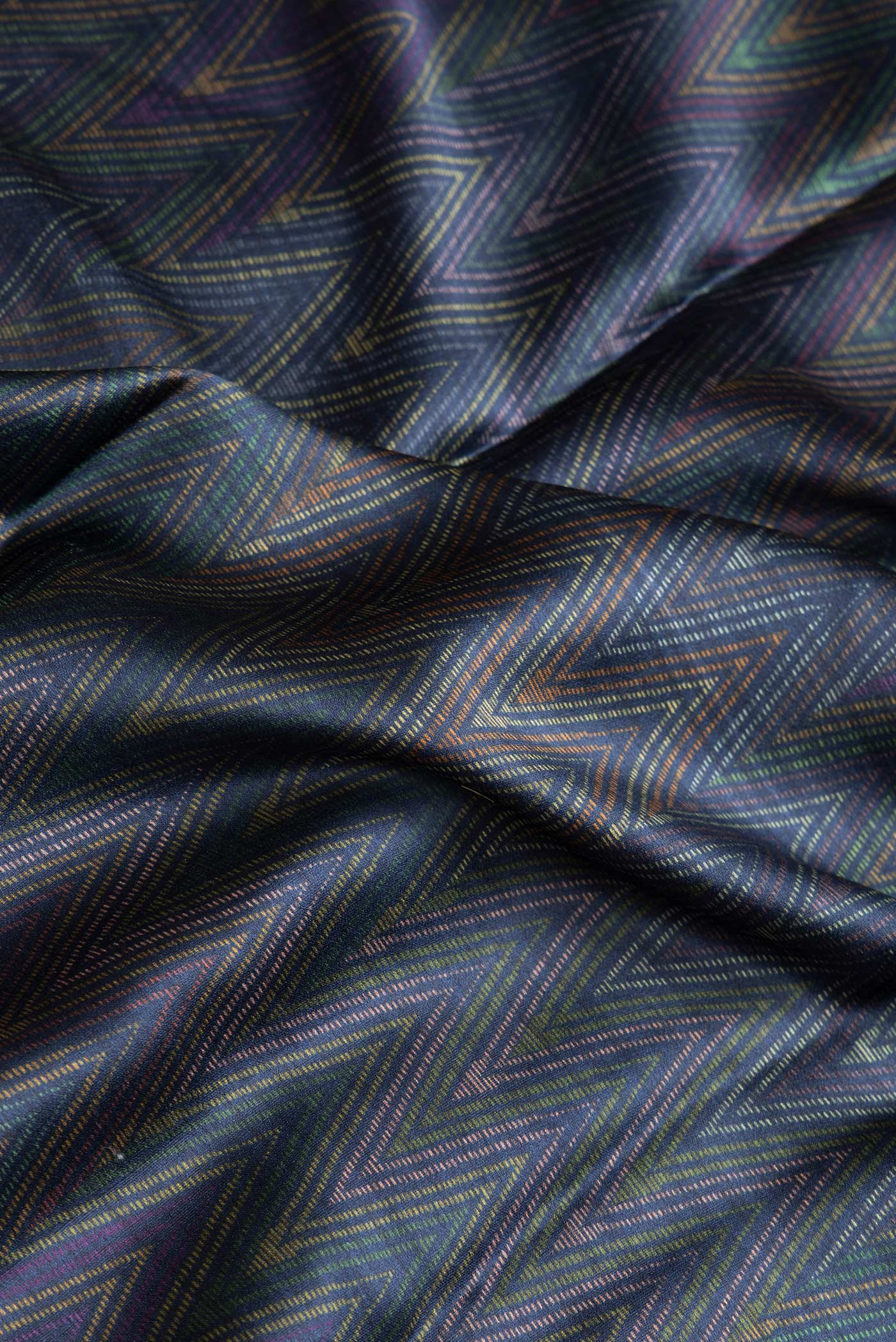Close up of Navy Blue Dual Tone Crepe Saree with Printed design on the body and Zari Border.  displaying folds