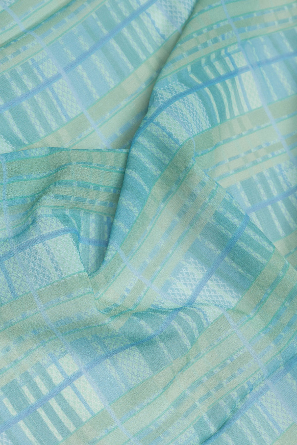 Close up of Mehandi Green Dual Tone Mysore Georgette Saree with Printed design on the body and Printed Border.  displaying folds