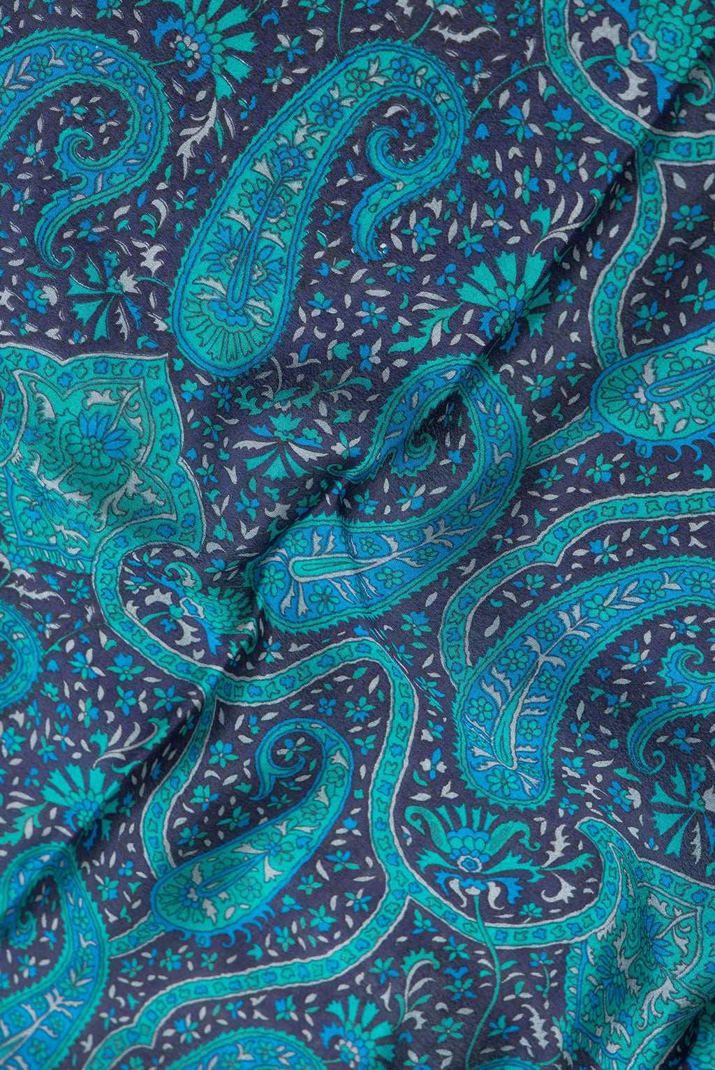 Close up of Navy Blue Dual Tone Crepe Saree with Printed design on the body and Zari Border.  displaying folds