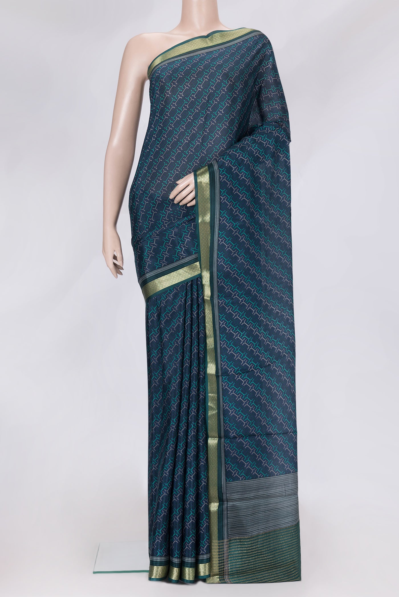 Peacock Blue Dual Tone Crepe Saree with Printed design on the body and Zari Border.  displayed on a mannequin