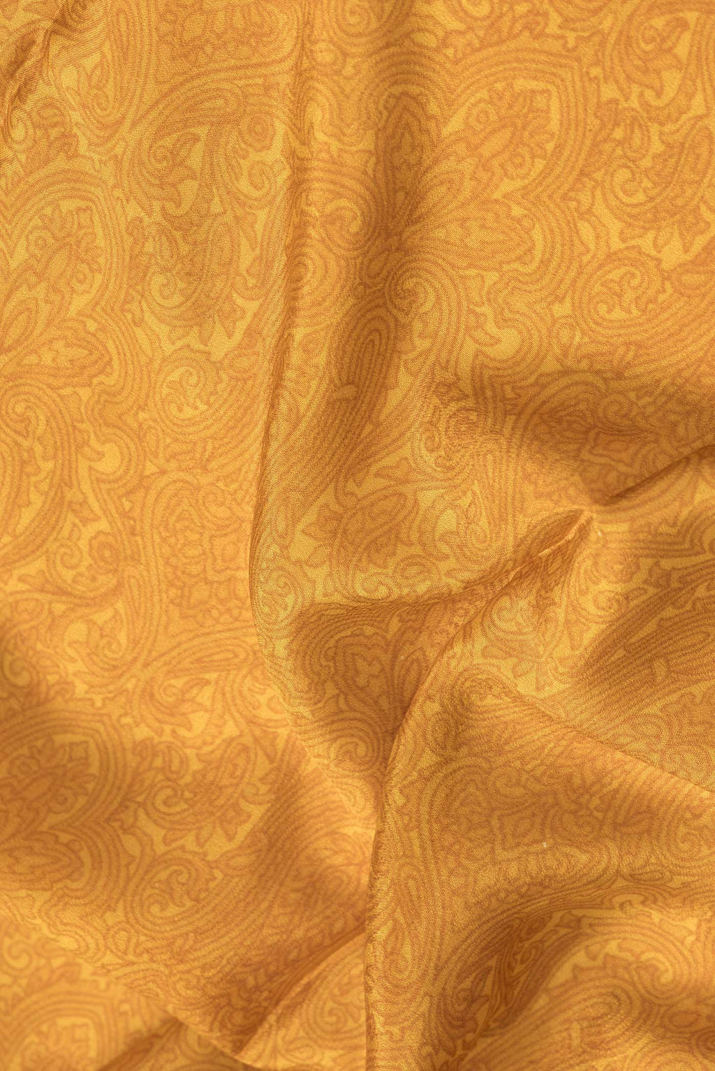 Close up of Mustard Dual Tone Crepe Saree with Printed design on the body and Zari Border.  displaying folds