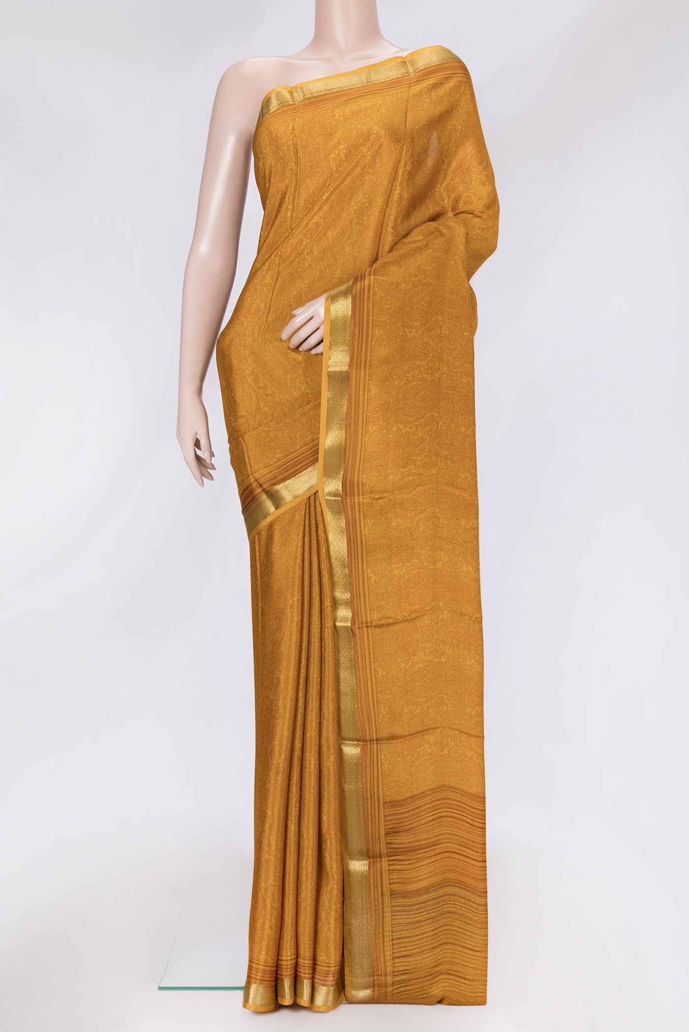 Mustard Dual Tone Crepe Saree with Printed design on the body and Zari Border.  displayed on a mannequin