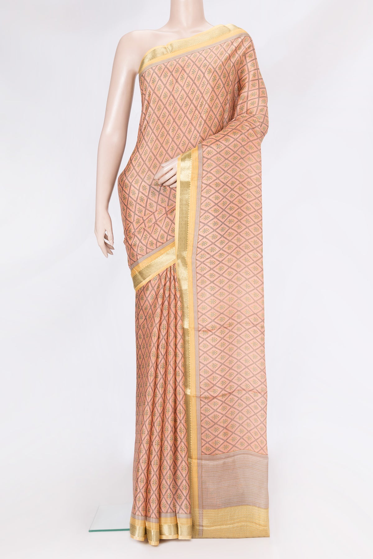 Peach Dual Tone Crepe Saree with Printed design on the body and Zari Border.  displayed on a mannequin