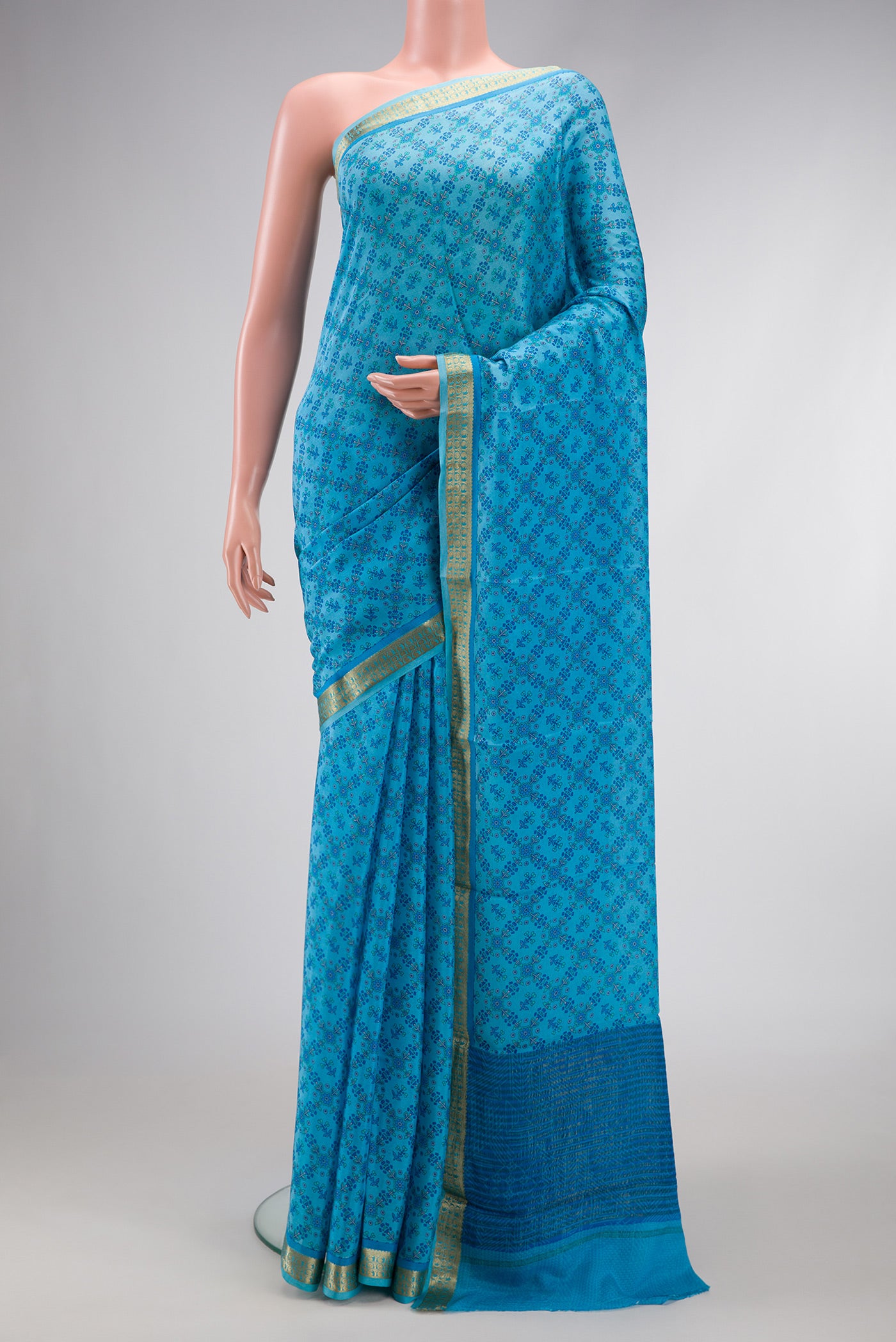Sky Blue Dual Tone Mysore Crepe Saree with Printed design on the body and Zari Border.  displayed on a mannequin