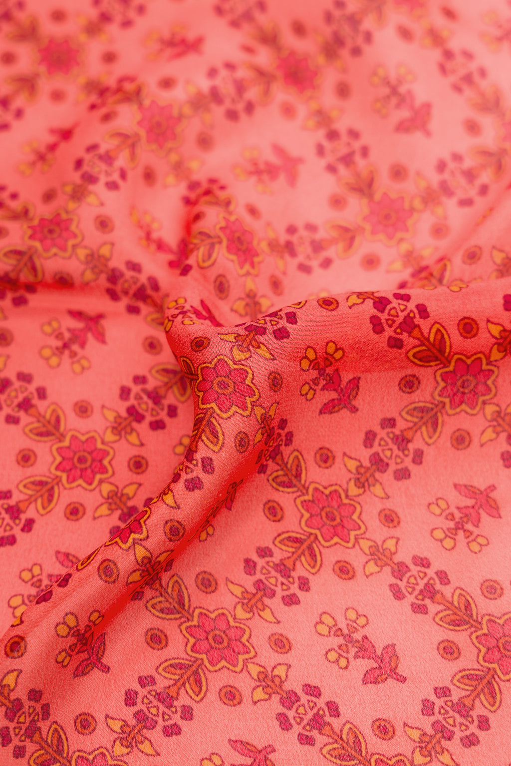 Close up of Golden Peach Dual Tone Mysore Crepe Saree with Printed design on the body and Zari Border.  displaying folds