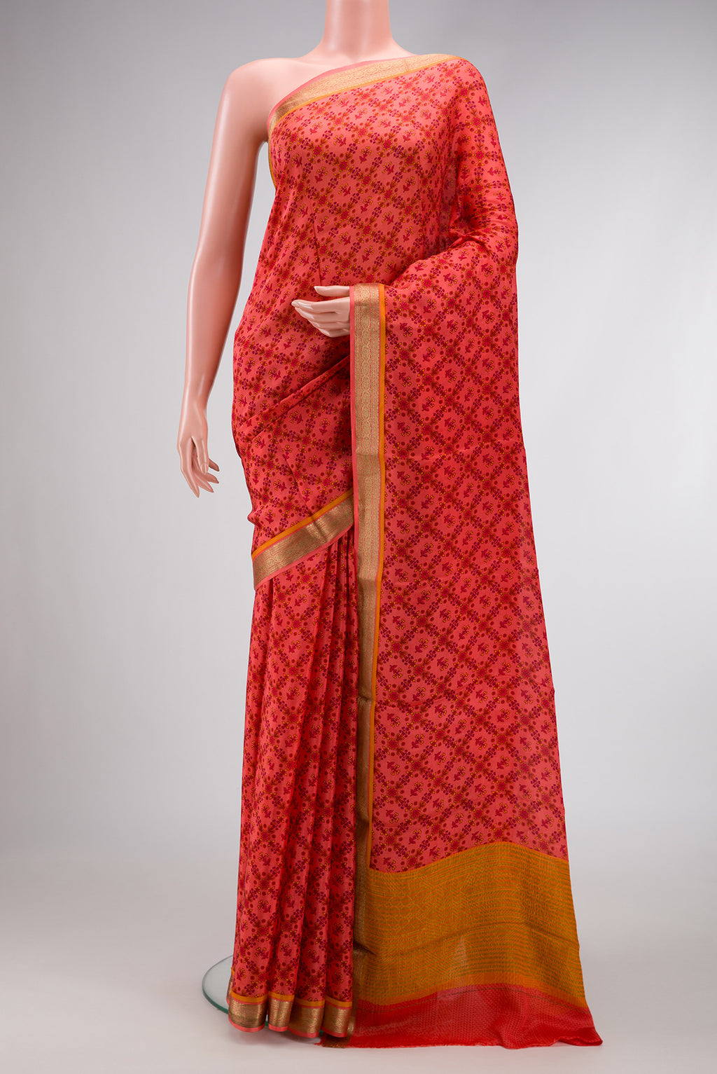 Golden Peach Dual Tone Mysore Crepe Saree with Printed design on the body and Zari Border.  displayed on a mannequin