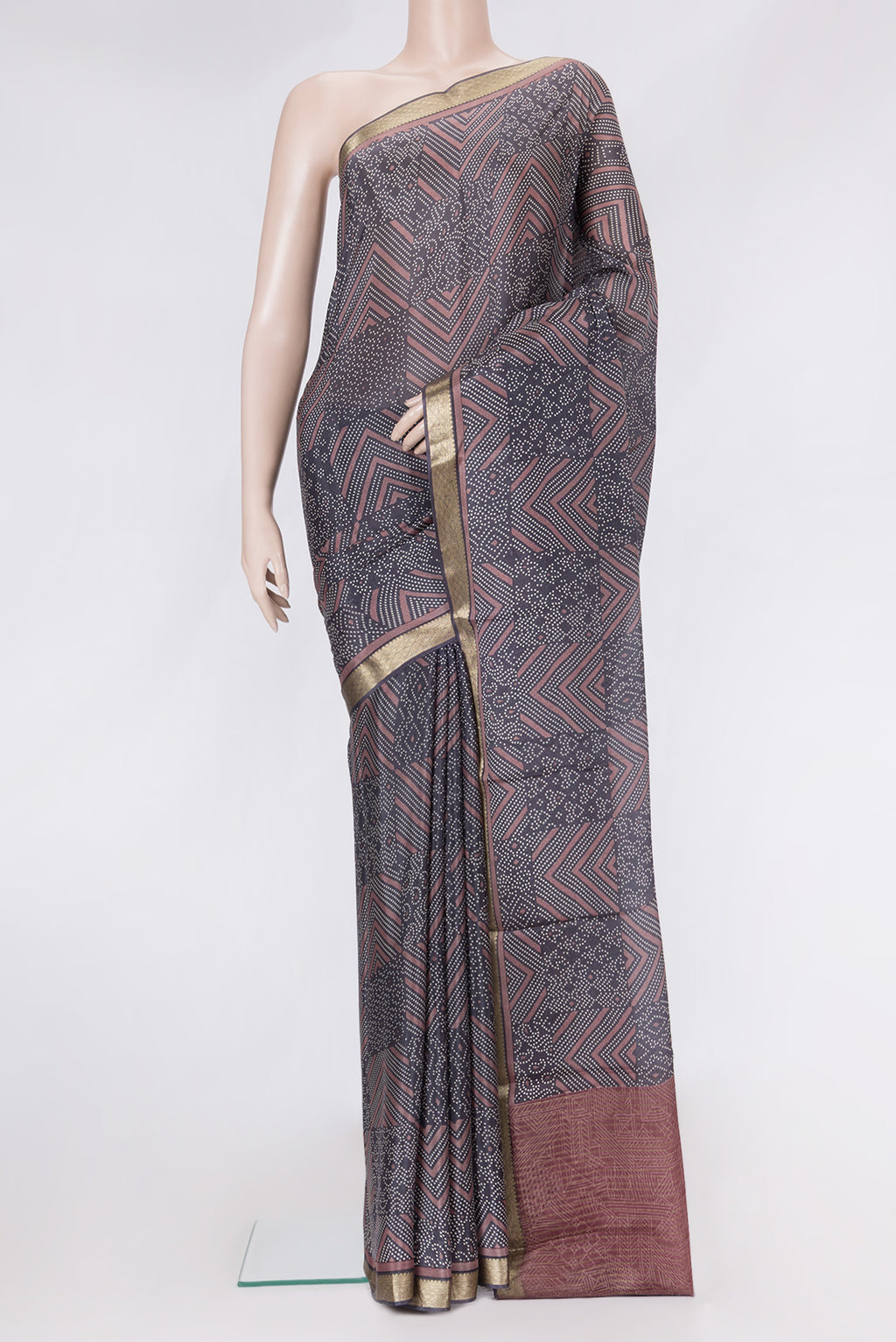 Brown Dual Tone Crepe Saree with Printed design on the body and Zari Border.  displayed on a mannequin
