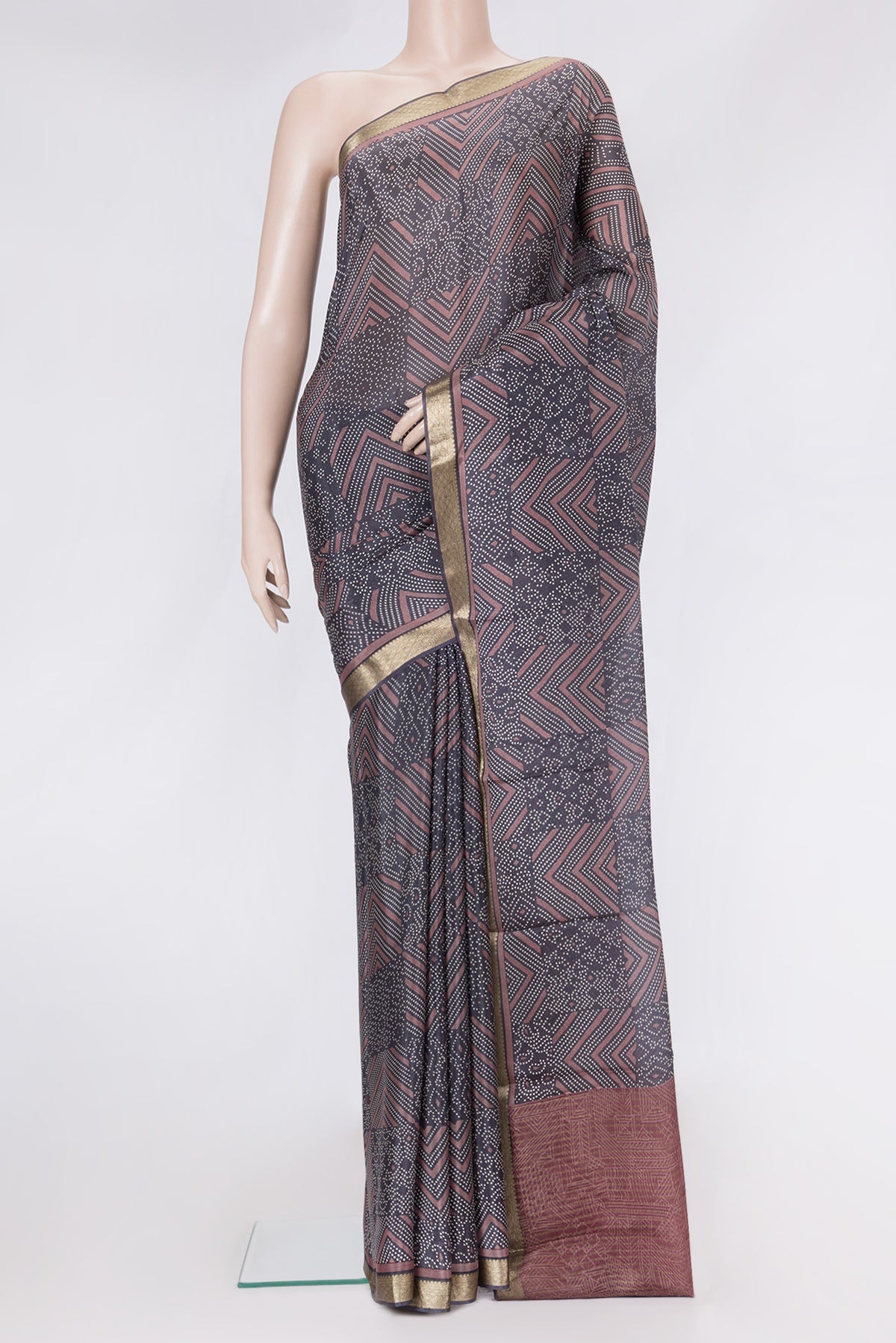 Brown Dual Tone Crepe Saree with Printed design on the body and Zari Border.  displayed on a mannequin