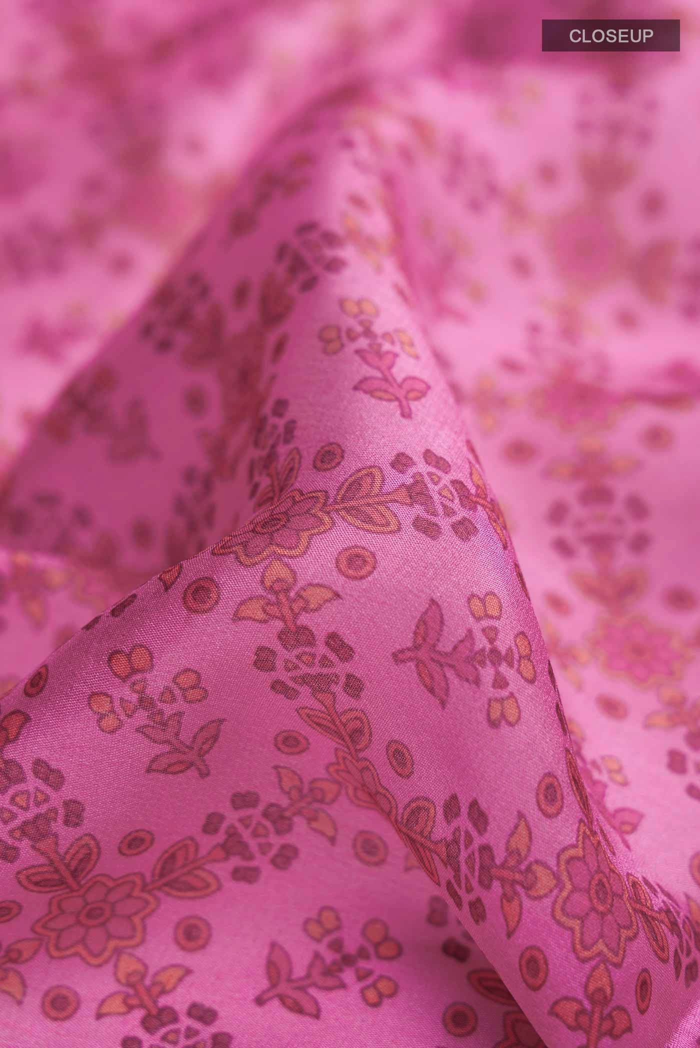 Close up of Pink Mysore Crepe Saree with Printed design on the body and Zari Border displaying folds